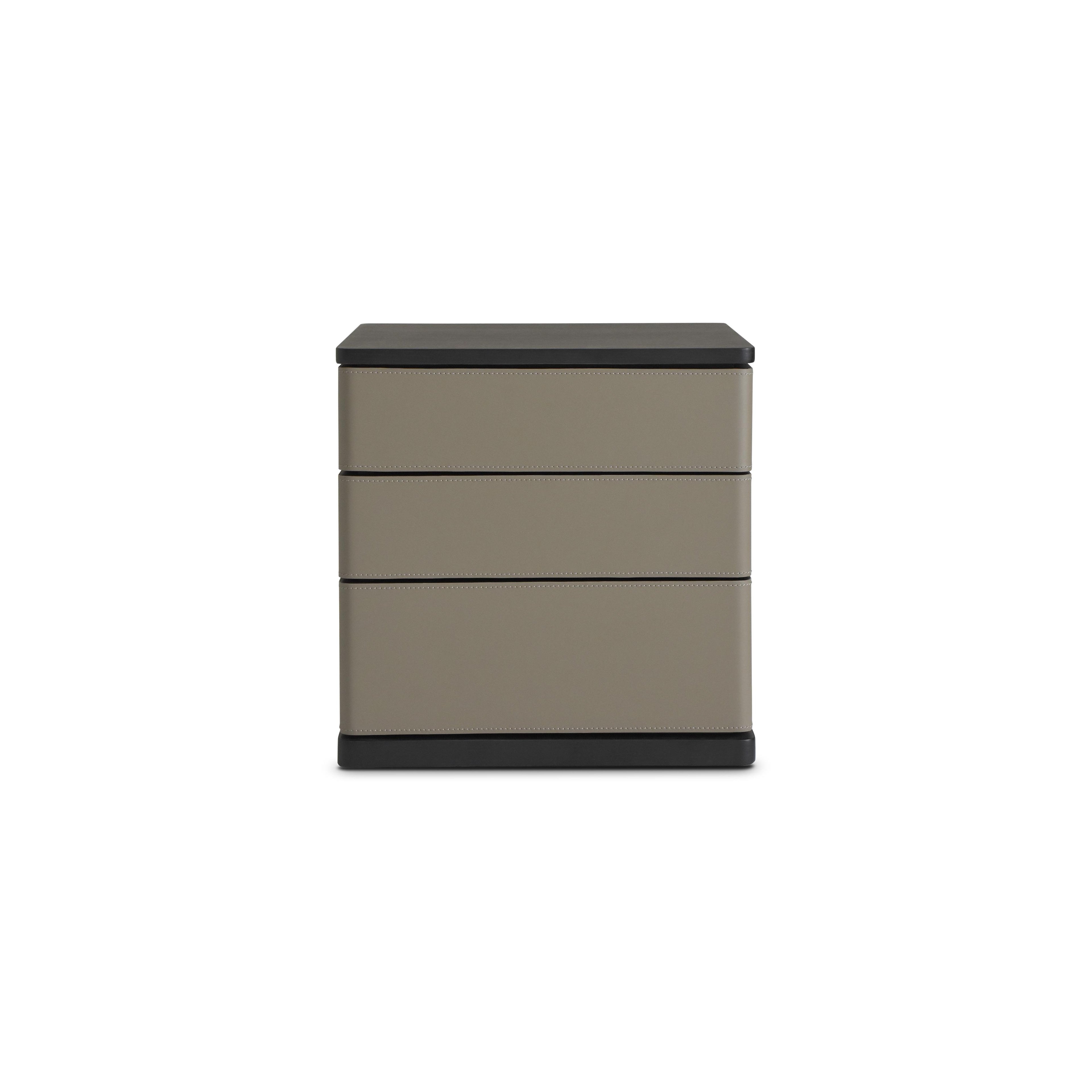 Three-drawer nightstand with matte taupe drawers and black top and base; rectangular form with vertical stitching along drawer edges; no handles or visible fasteners; intended for bedside storage; Category: furniture/nightside-tables