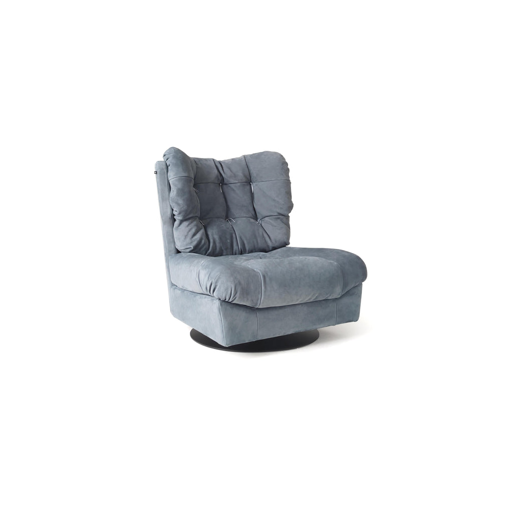 A single swivel armchair with a plush, gray fabric upholstery, featuring a tufted backrest and cushioned seat, supported by a circular black base; designed for seated comfort and rotation; Category: Furniture > Chairs > Swivel Chairs