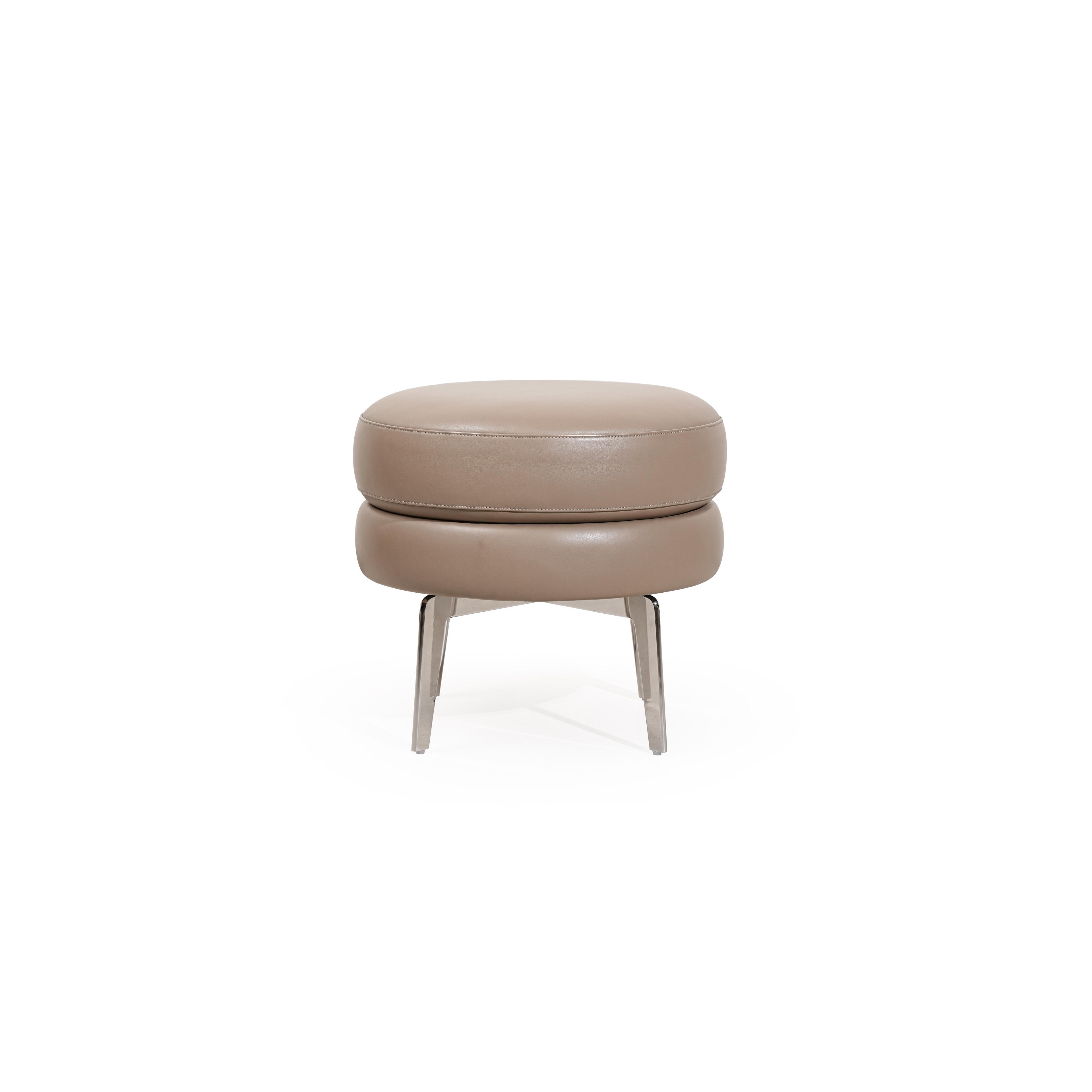 Round upholstered ottoman with two stacked cushion layers in light beige fabric, supported by four slender metallic legs; designed for seating or footrest use; features subtle stitching and clean lines; Category: Furniture > Ottomans