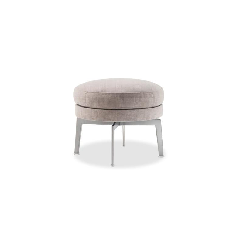 Round upholstered ottoman with two stacked cushion layers in light beige fabric, supported by four slender metallic legs; designed for seating or footrest use; features subtle stitching and clean lines; Category: Furniture > Ottomans