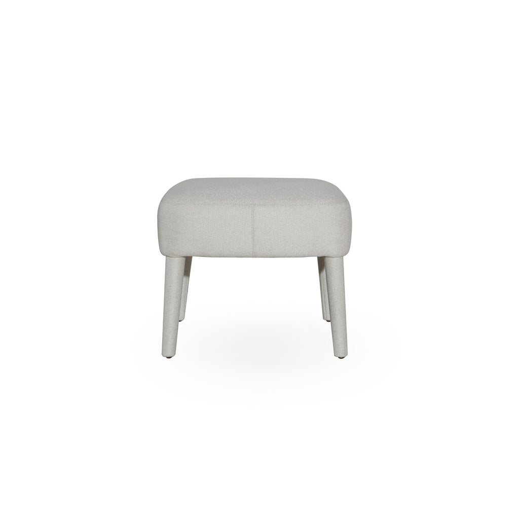 This upholstered stool has a rectangular seat with visible stitching and four tapered legs. The fabric upholstery is light gray with a textured weave. It is designed for seating or as a footrest. Category: Furniture > Stools