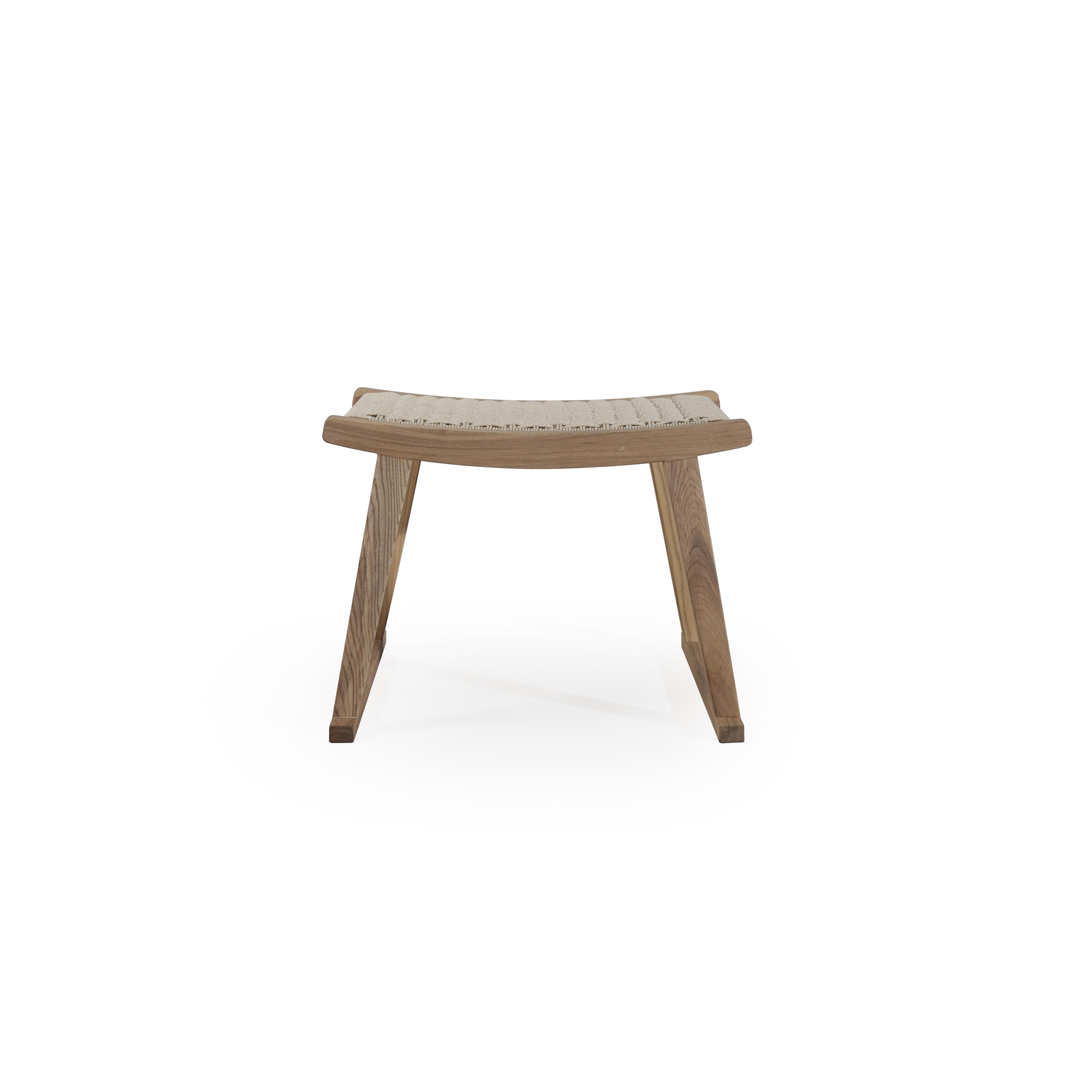 A wooden footstool with a curved, woven seat surface and angled legs forming a stable base. The seat features a light-colored, tightly woven texture. The frame is made of wood with visible grain. Intended for footrest use. Category: Furniture > Stools > Footstools