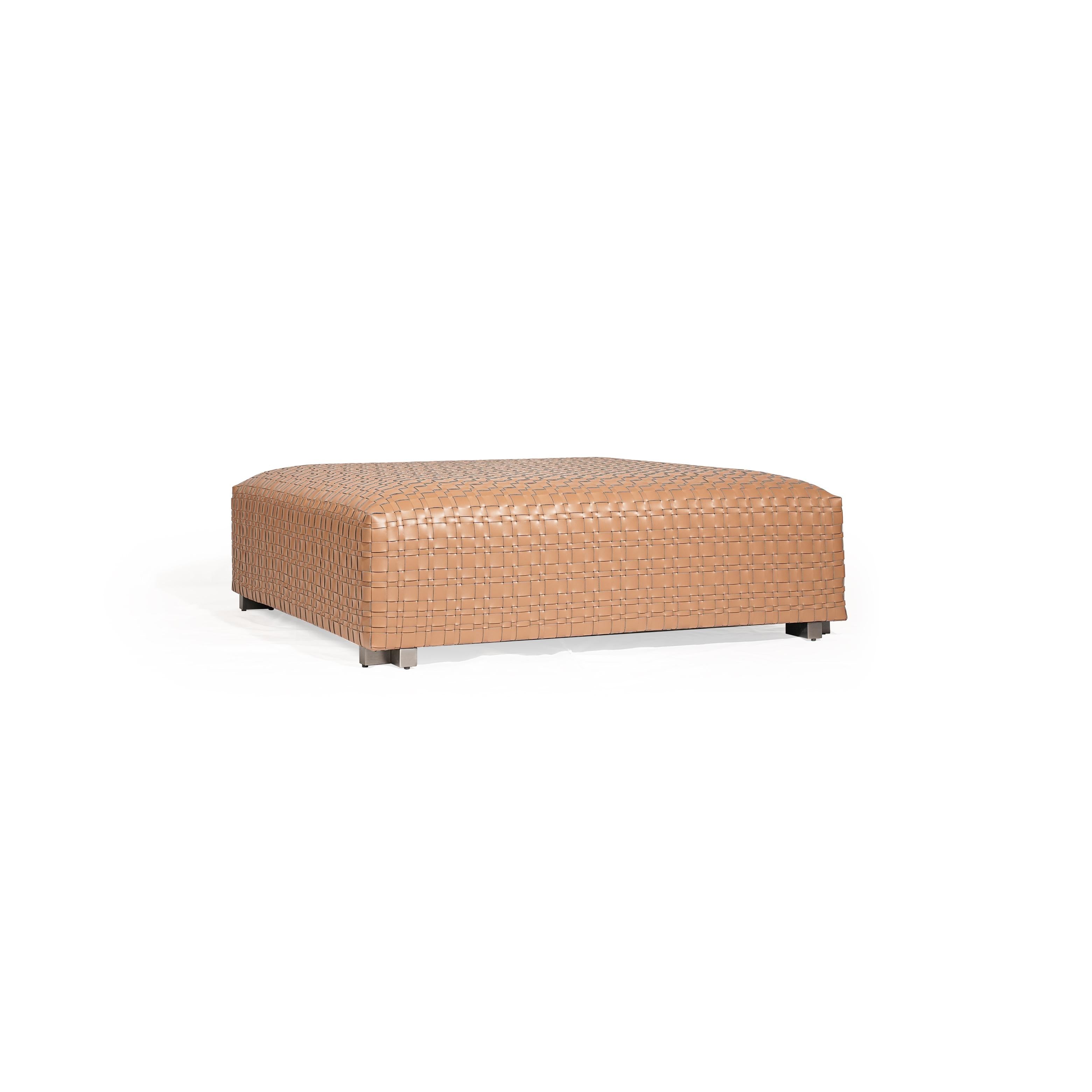 Rectangular ottoman with tan woven leather surface, four short metallic legs, and a uniform grid pattern across its top and sides, designed for seating or as a footrest. Category: Furniture > Seating > Ottomans