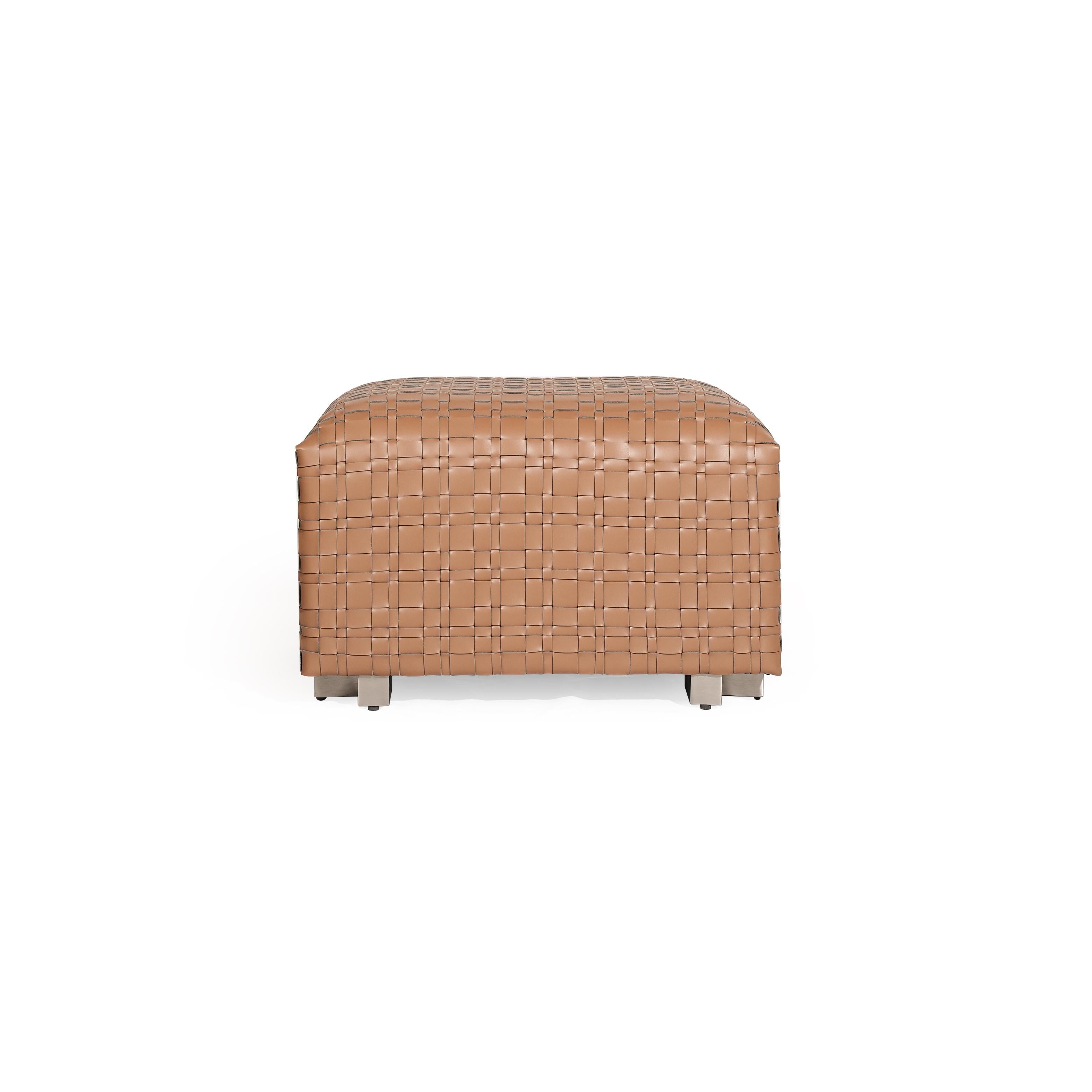 Rectangular ottoman with tan woven leather surface, four short metallic legs, and a uniform grid pattern across its top and sides, designed for seating or as a footrest. Category: Furniture > Seating > Ottomans