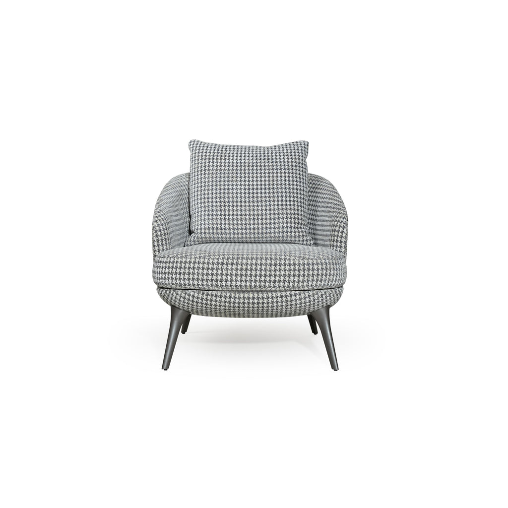 A upholstered armchair with a houndstooth pattern in gray and white, featuring rounded contours, four tapered legs, and a matching back cushion, designed for seated comfort in a living space. Category: Furniture > Chairs > Armchairs
