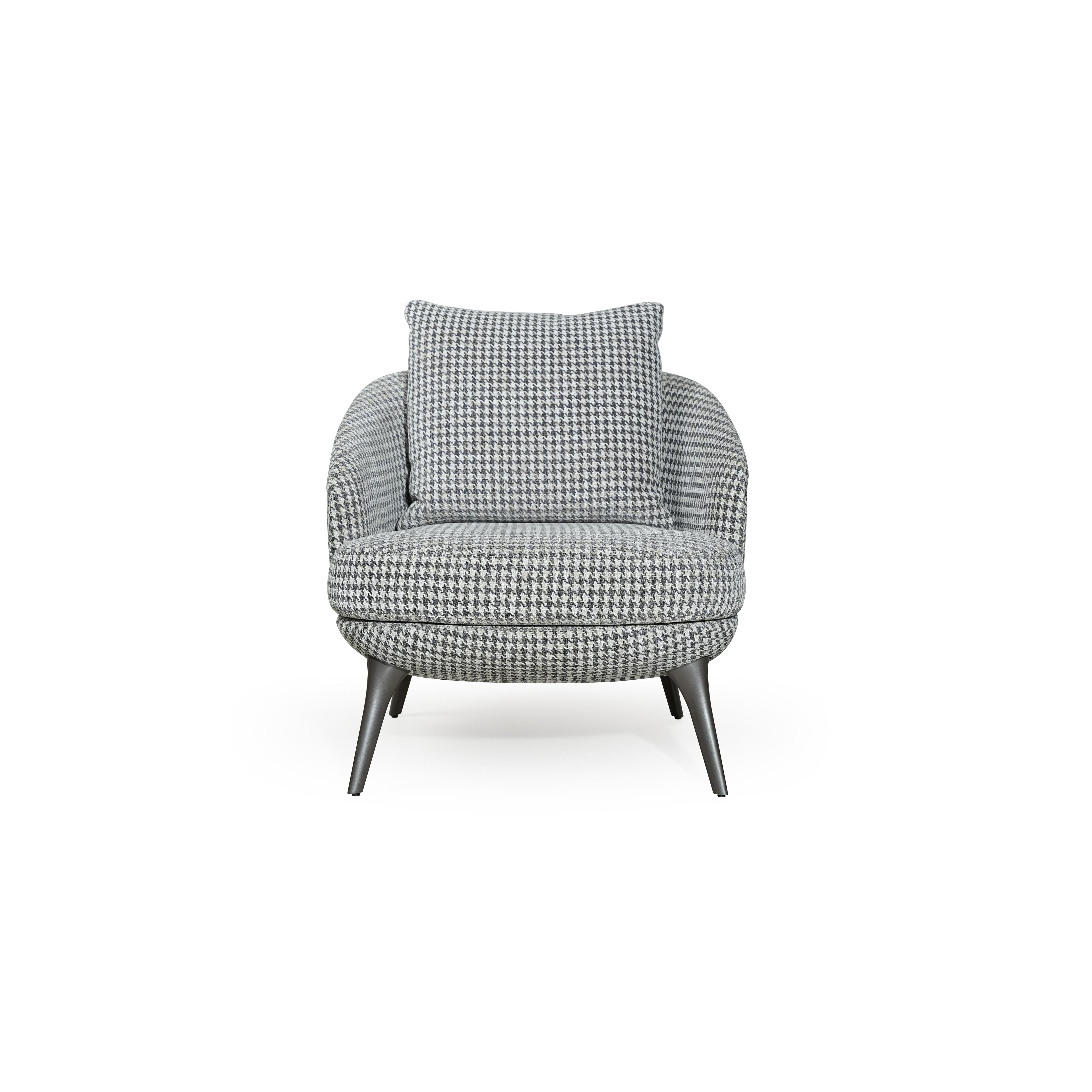 A upholstered armchair with a houndstooth pattern in gray and white, featuring rounded contours, four tapered legs, and a matching back cushion, designed for seated comfort in a living space. Category: Furniture > Chairs > Armchairs