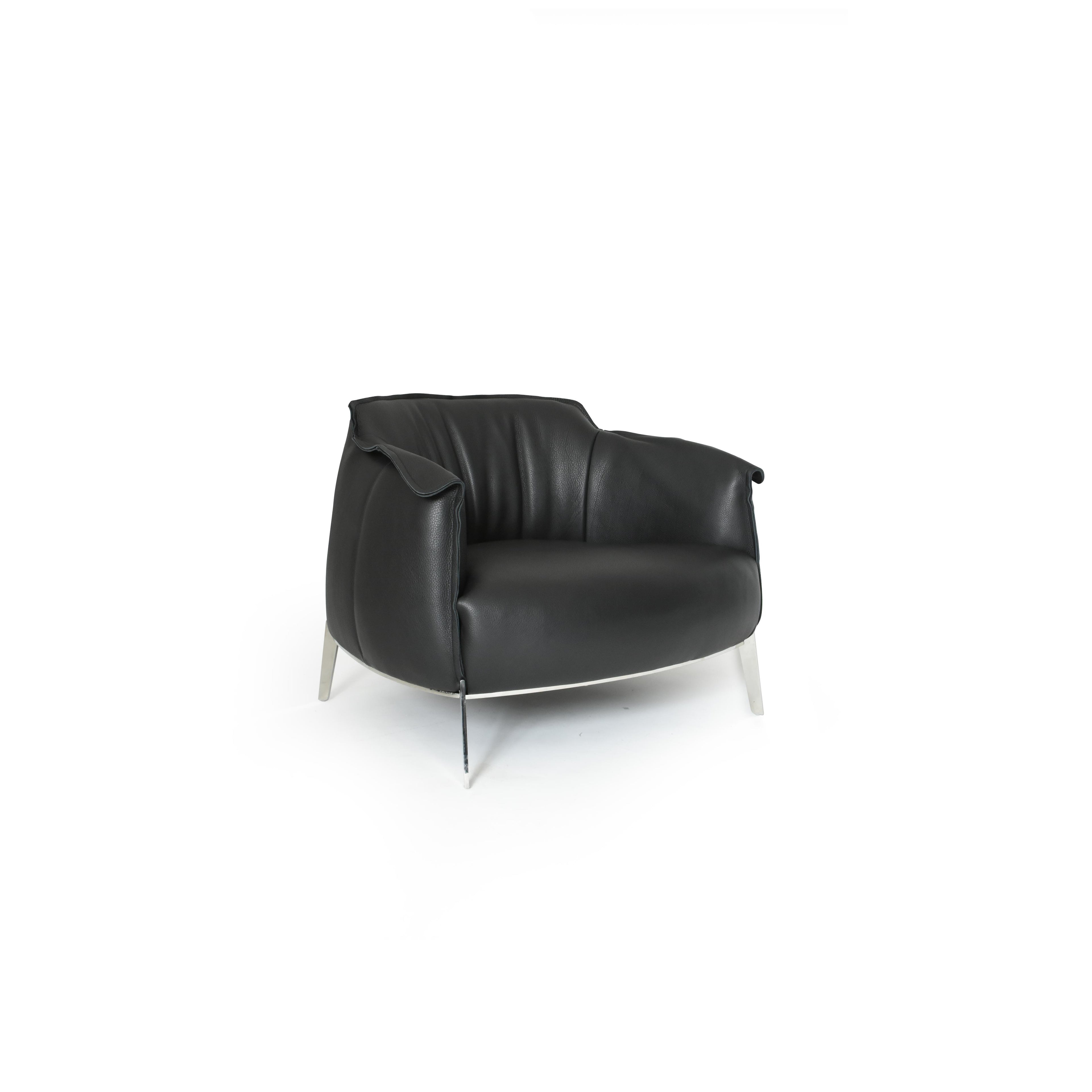 Black leather-like upholstered armchair with curved backrest, padded arms, and a rounded seat supported by four slender metallic legs; designed for seated comfort in living or lounge areas. Category: furniture/armchairs