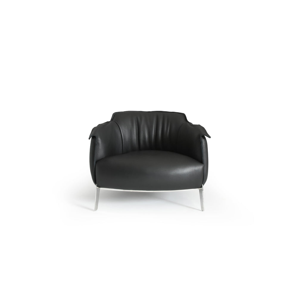 Black leather-like upholstered armchair with curved backrest, padded arms, and a rounded seat supported by four slender metallic legs; designed for seated comfort in living or lounge areas. Category: furniture/armchairs