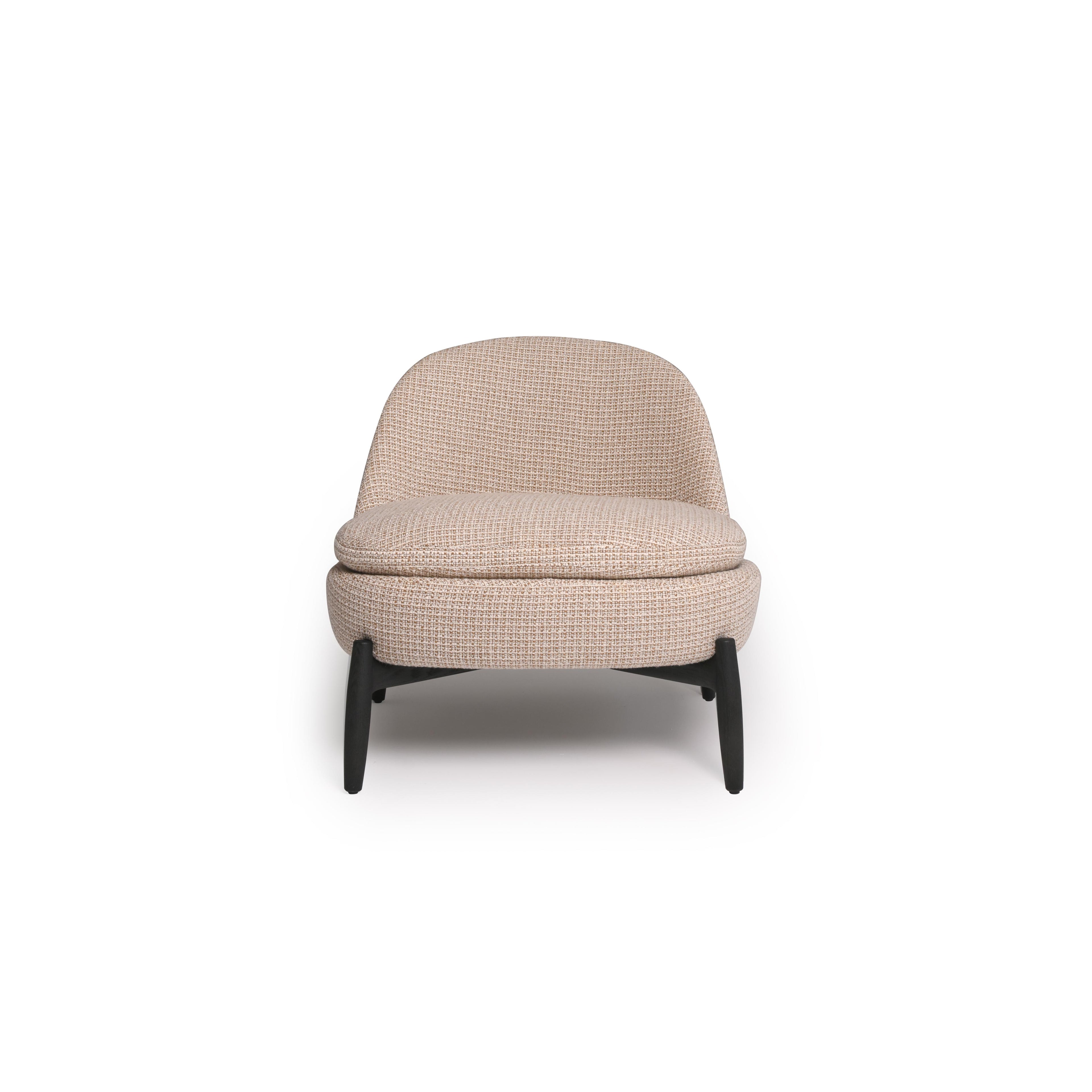 This is a single-seater armchair with a rounded backrest and seat, upholstered in a beige woven fabric. It has four dark, tapered legs supporting the frame. The cushioned seat and backrest are stitched together with visible seams. Intended for seating, it features a compact, modern silhouette. Category: Furniture > Chairs > Armchairs