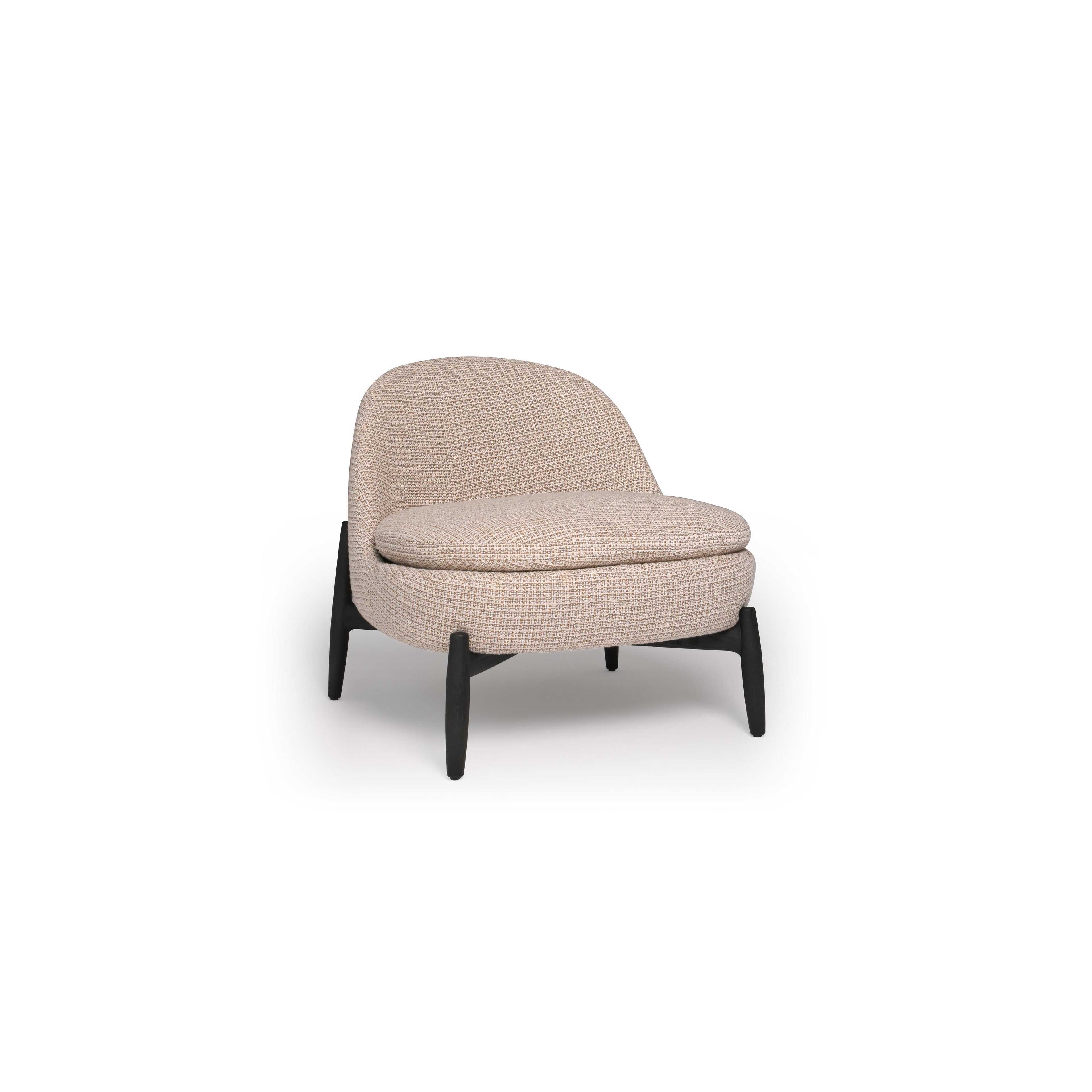 This is a single-seater armchair with a rounded backrest and seat, upholstered in a beige woven fabric. It has four dark, tapered legs supporting the frame. The cushioned seat and backrest are stitched together with visible seams. Intended for seating, it features a compact, modern silhouette. Category: Furniture > Chairs > Armchairs