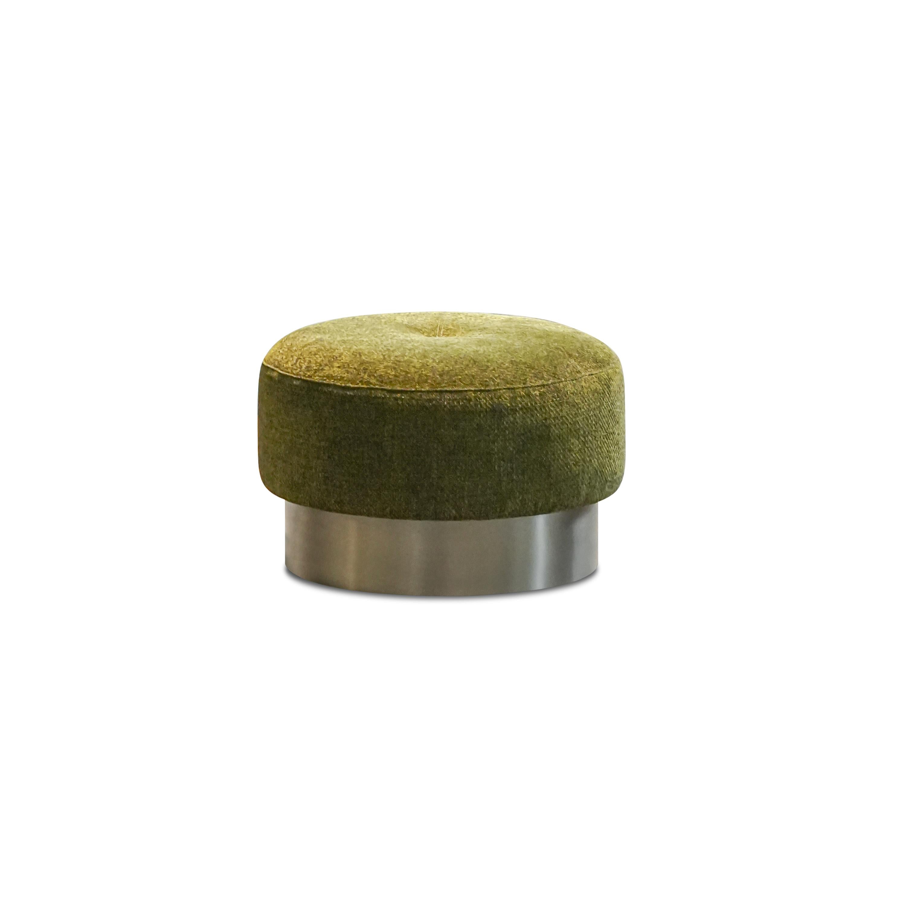 Round upholstered ottoman with olive green velvet top and metallic cylindrical base. Features tufted center cushion, smooth fabric surface, and sleek metal ring support. Designed for seating or footrest use. Category: Furniture > Ottomans