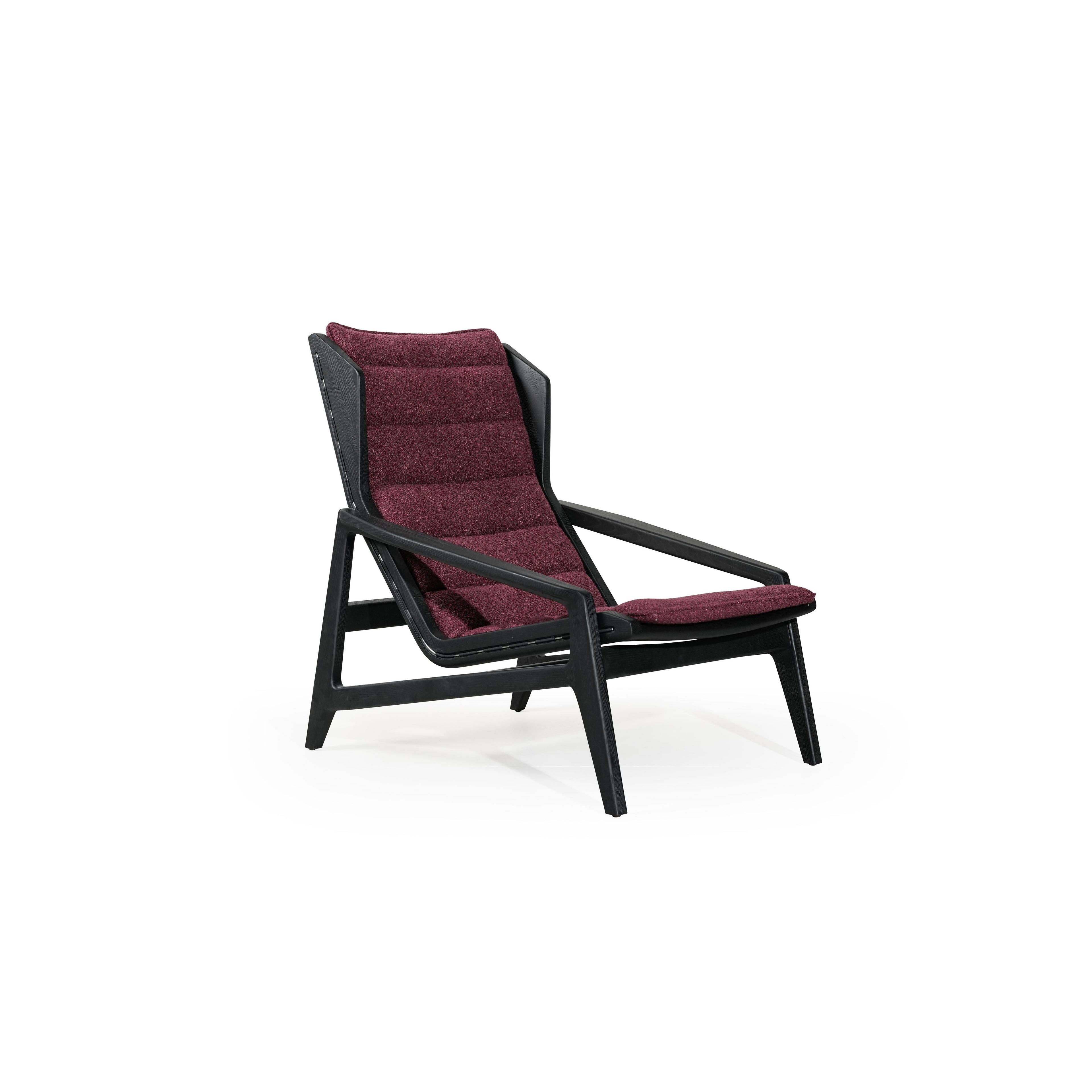Modern lounge chair with black frame and deep burgundy upholstered cushions. Features angled legs, continuous backrest, and integrated armrests. Fabric has textured surface. Designed for seated relaxation. Category: Furniture > Chairs > Lounge Chairs
