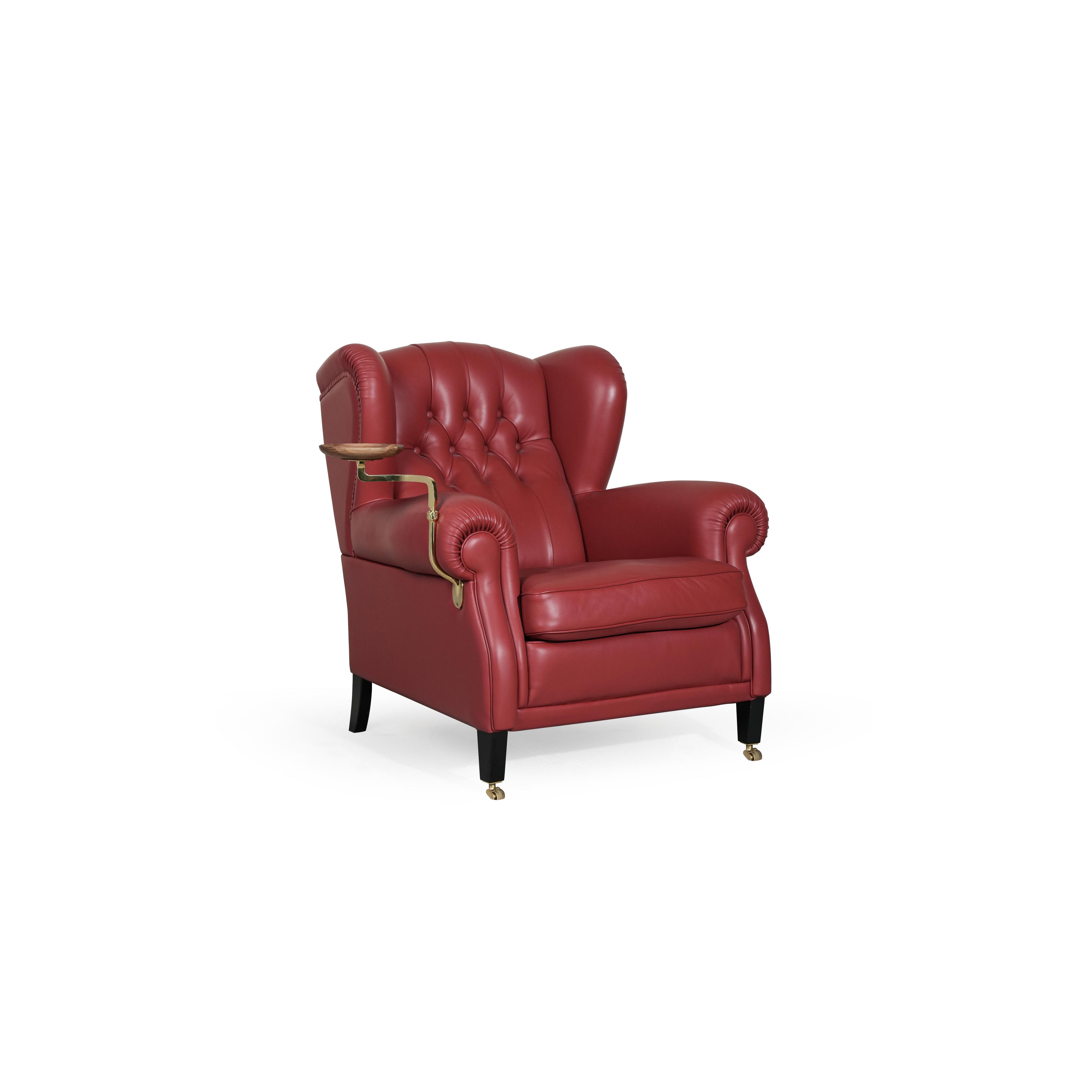 Red leather-like upholstered wingback armchair with tufted back, rolled arms, and a side-mounted wooden tray on brass armrest. Black legs with brass casters. Designed for seated comfort and display. Category: Furniture > Chairs > Armchairs