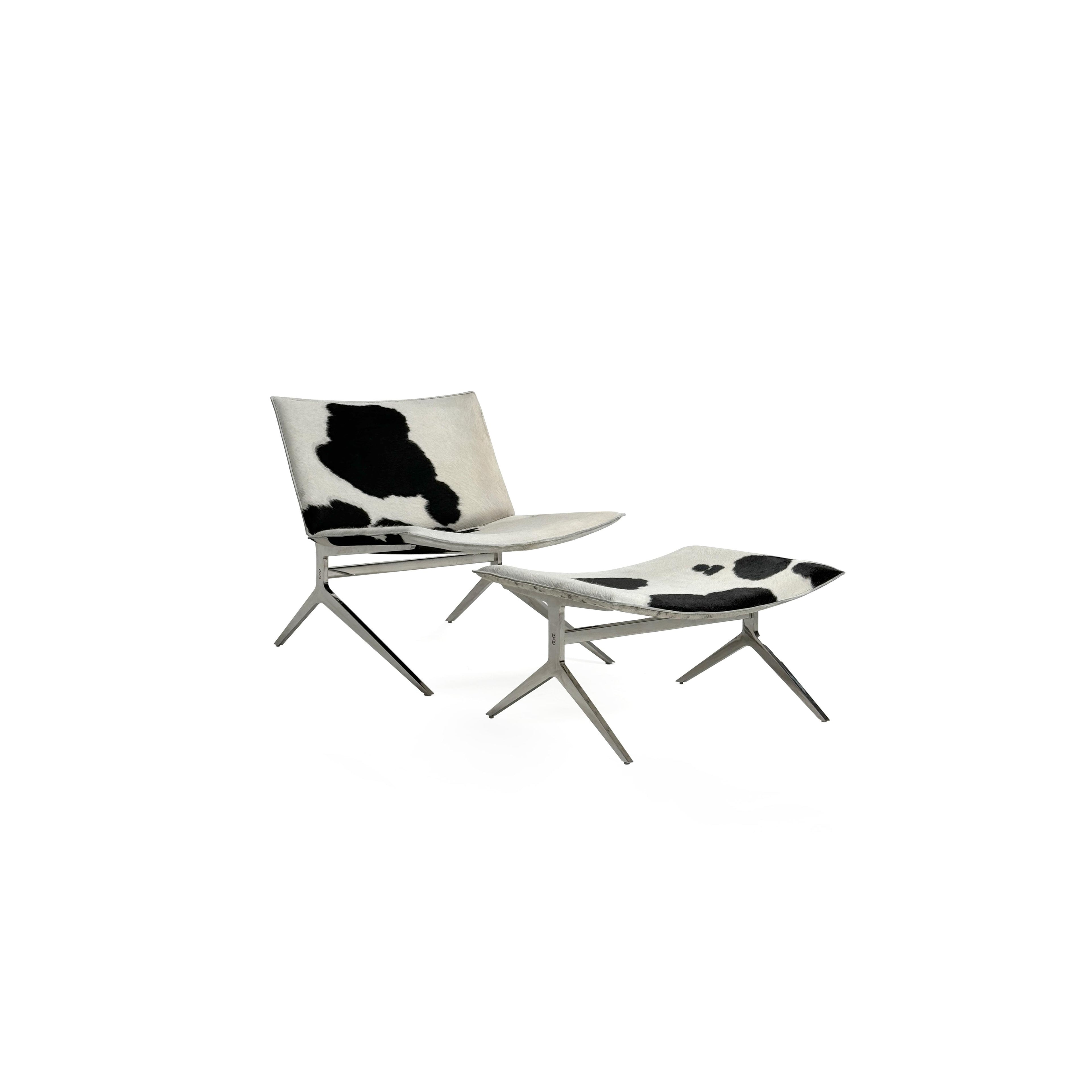 This is a modern lounge chair with a black and white cowhide upholstery on the seat and backrest, supported by a sleek, metallic X-shaped base. The chair has no arms or cushions, and its structure is minimalist. Intended for casual seating, it features a flat, continuous surface for comfort. Category: Furniture > Chairs > Lounge Chairs