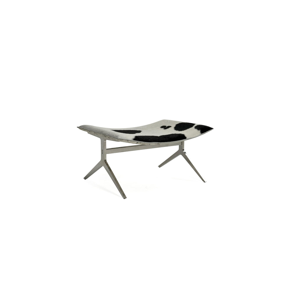 This is a modern lounge chair with a black and white cowhide upholstery on the seat and backrest, supported by a sleek, metallic X-shaped base. The chair has no arms or cushions, and its structure is minimalist. Intended for casual seating, it features a flat, continuous surface for comfort. Category: Furniture > Chairs > Lounge Chairs