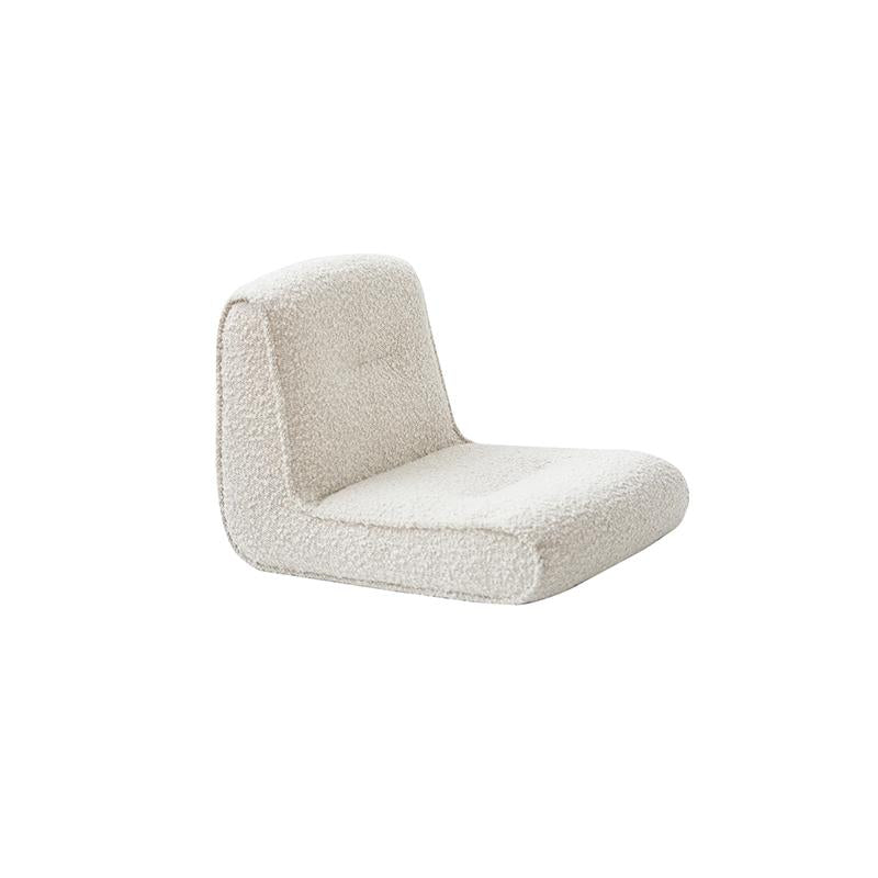 This is a single-seater upholstered chair with a low-profile, angular form. It features a continuous backrest and seat cushion, covered in a textured, off-white boucle fabric. No visible legs or frame structure. Intended for casual seating. Category: furniture/chairs/single-seater