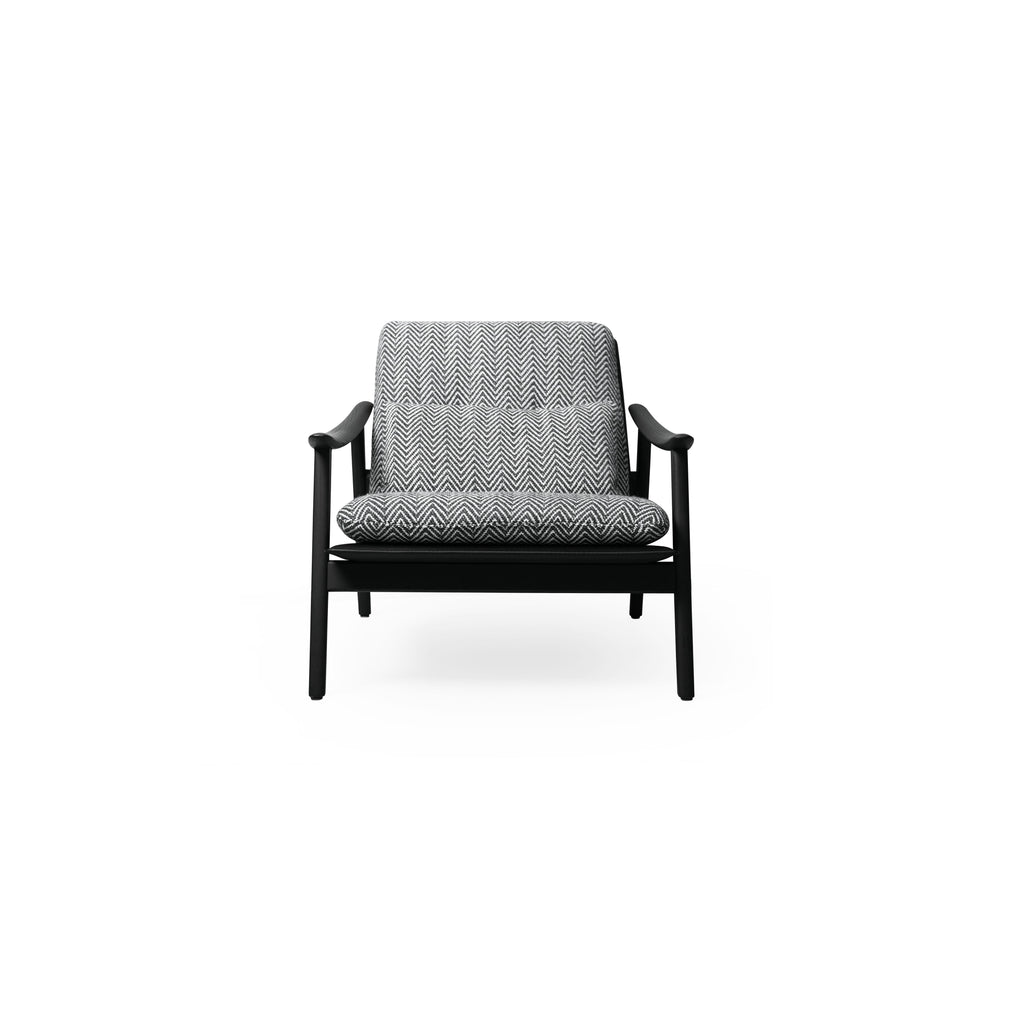 A single armchair with a black frame and herringbone-patterned fabric upholstery. It features curved arms, four angled legs, a cushioned seat and backrest, and visible stitching. Designed for seating, it has a modern silhouette with a low-profile base. Category: Furniture > Chairs > Armchairs