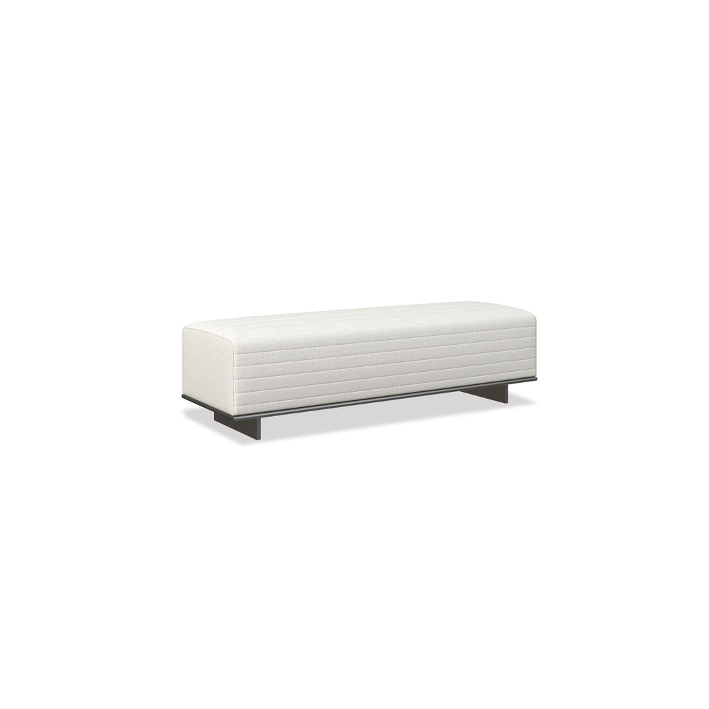 A rectangular upholstered bench with a white fabric surface featuring horizontal stitching. It rests on two dark metal legs. Designed for seating, it has a low profile and no arms or backrest. Category: Furniture > Seating > Bench