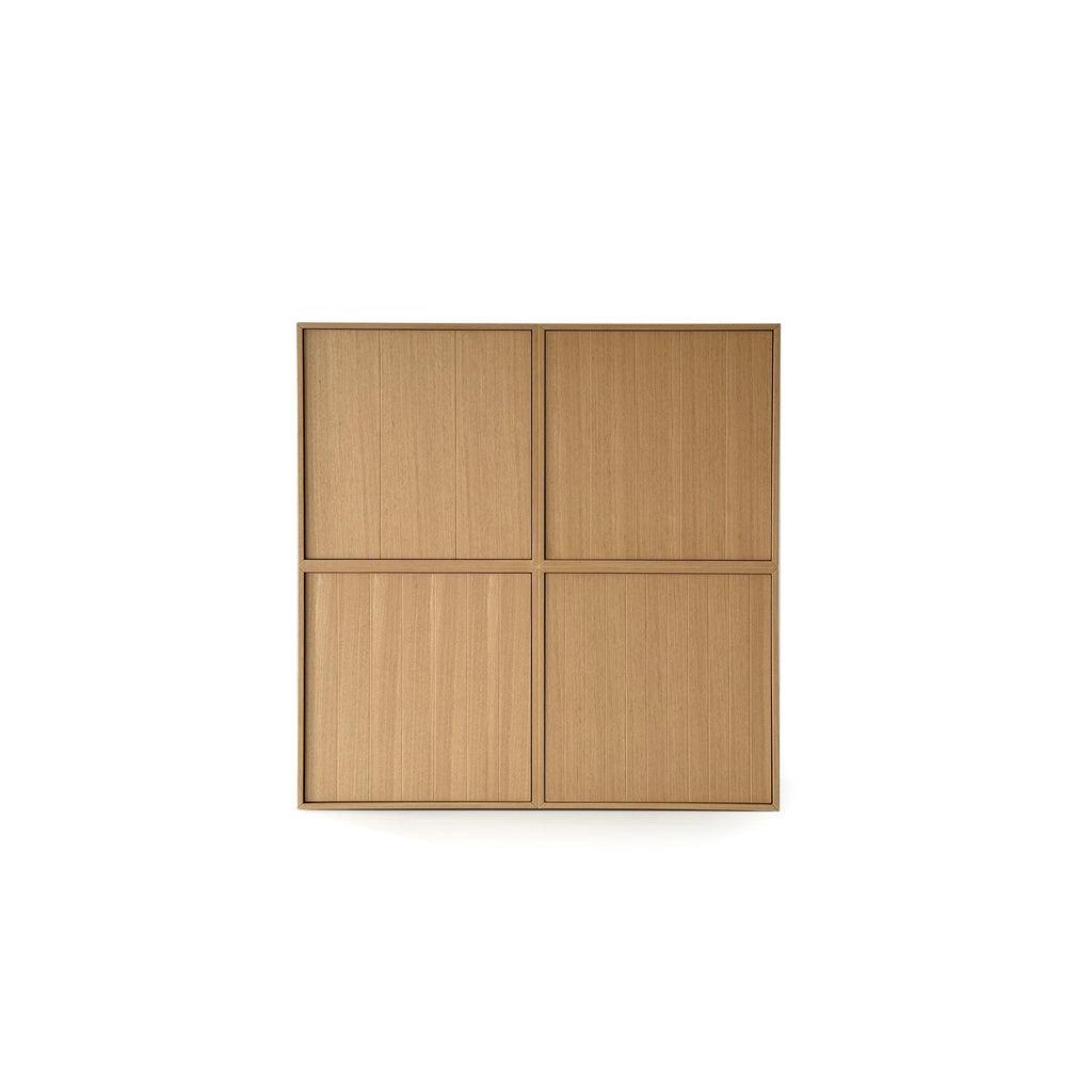 This is a four-door storage cabinet with a light wood finish and vertical grain texture. It has a rectangular form with two doors on each of two vertical sections. The doors are flush with the frame and have no visible handles or fasteners. Intended for general storage, it features a clean, minimalist design. Category: furniture > storage > cabinets