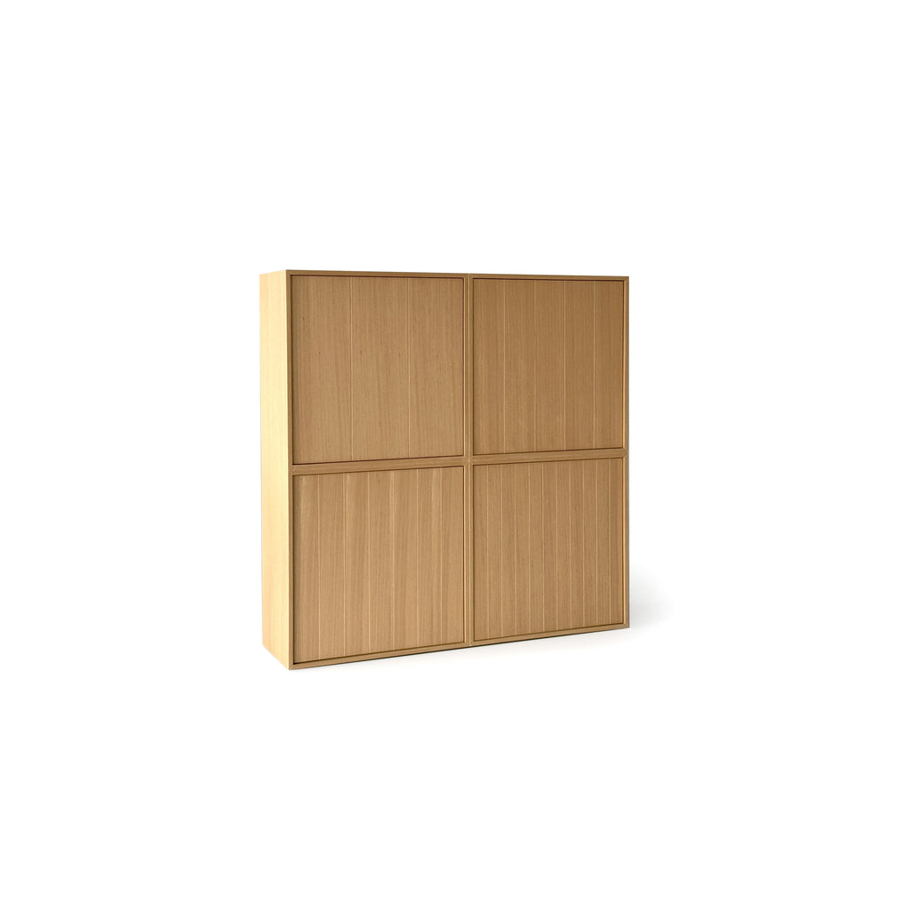 This is a four-door storage cabinet with a light wood finish and vertical grain texture. It has a rectangular form with two doors on each of two vertical sections. The doors are flush with the frame and have no visible handles or fasteners. Intended for general storage, it features a clean, minimalist design. Category: furniture > storage > cabinets