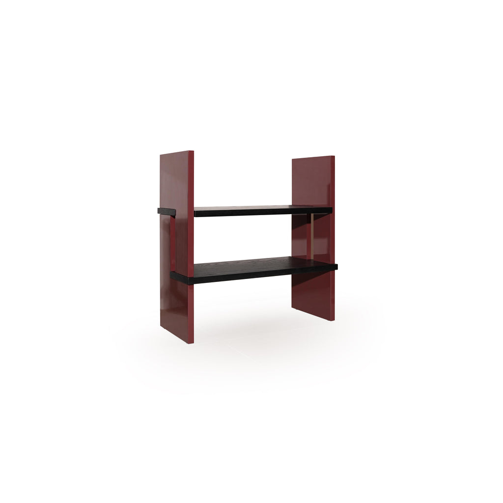 Two-tiered shelf unit with dark gray wooden shelves and glossy red vertical supports; rectangular form with no back or arms; intended for displaying items; Category: Furniture > Shelves > Display Shelves