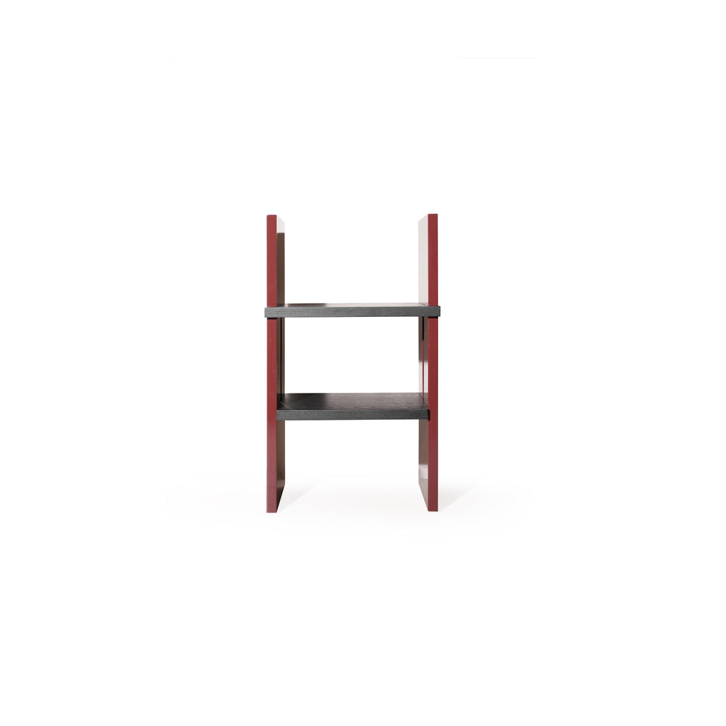 Two-tiered shelf unit with dark gray wooden shelves and glossy red vertical supports; rectangular form with no back or arms; intended for displaying items; Category: Furniture > Shelves > Display Shelves