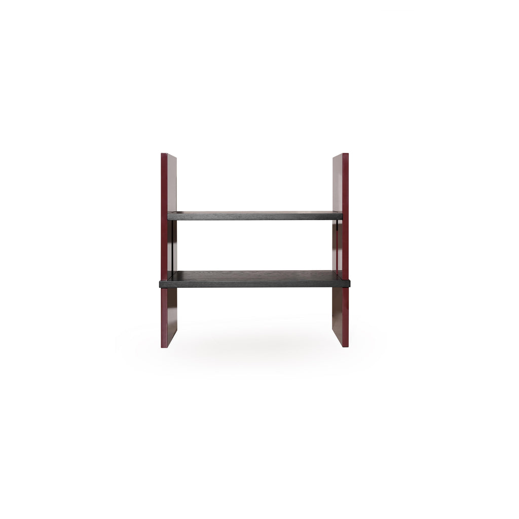 Two-tiered shelf unit with dark gray wooden shelves and glossy red vertical supports; rectangular form with no back or arms; intended for displaying items; Category: Furniture > Shelves > Display Shelves