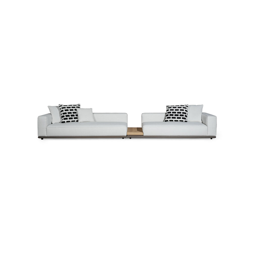 Two-seater modular sofa with white fabric upholstery, black and white patterned cushions, low-profile dark base, and wooden center table insert; designed for seating, featuring armrests, backrests, and visible stitching; Category: furniture/sofas/modular-sofas