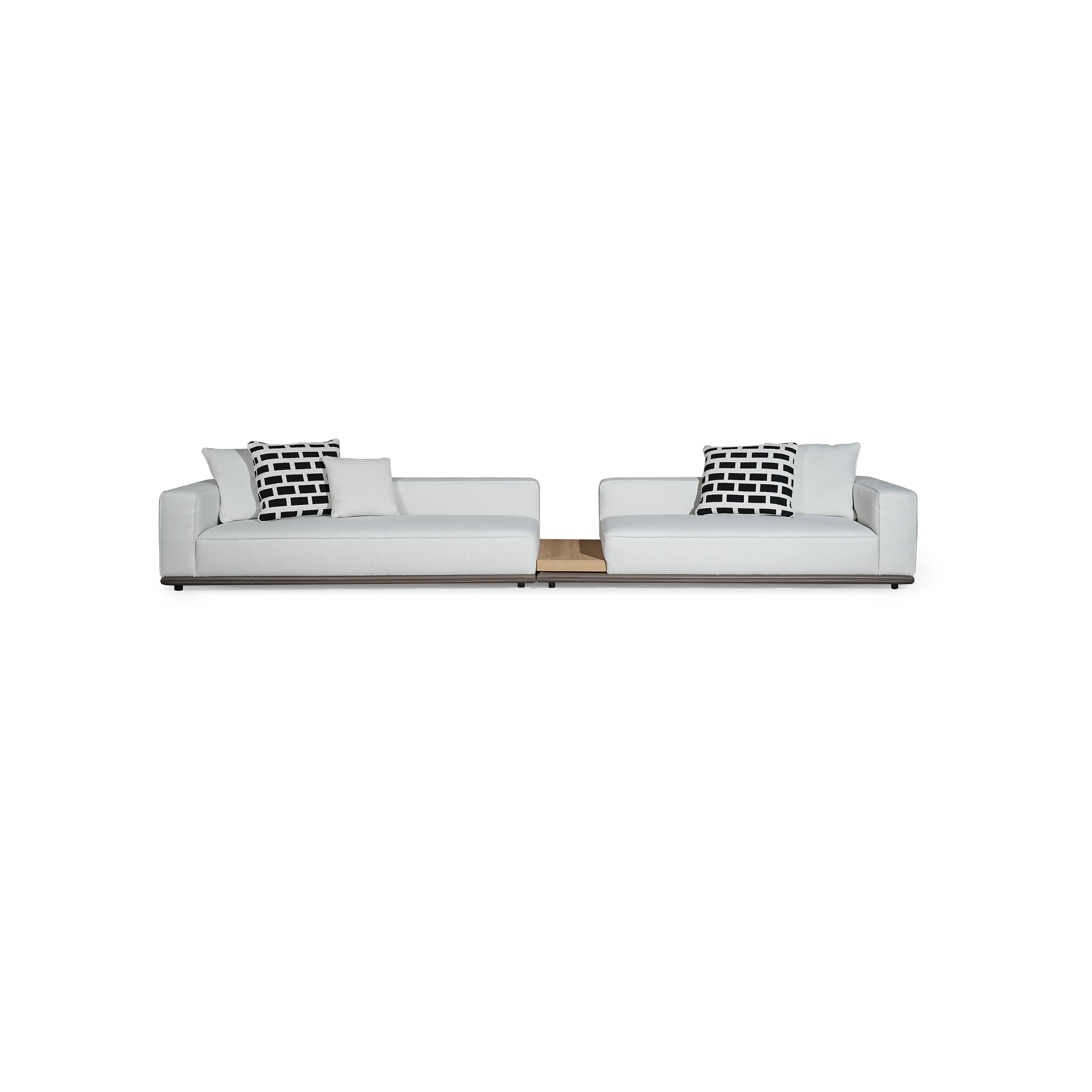 Two-seater modular sofa with white fabric upholstery, black and white patterned cushions, low-profile dark base, and wooden center table insert; designed for seating, featuring armrests, backrests, and visible stitching; Category: furniture/sofas/modular-sofas