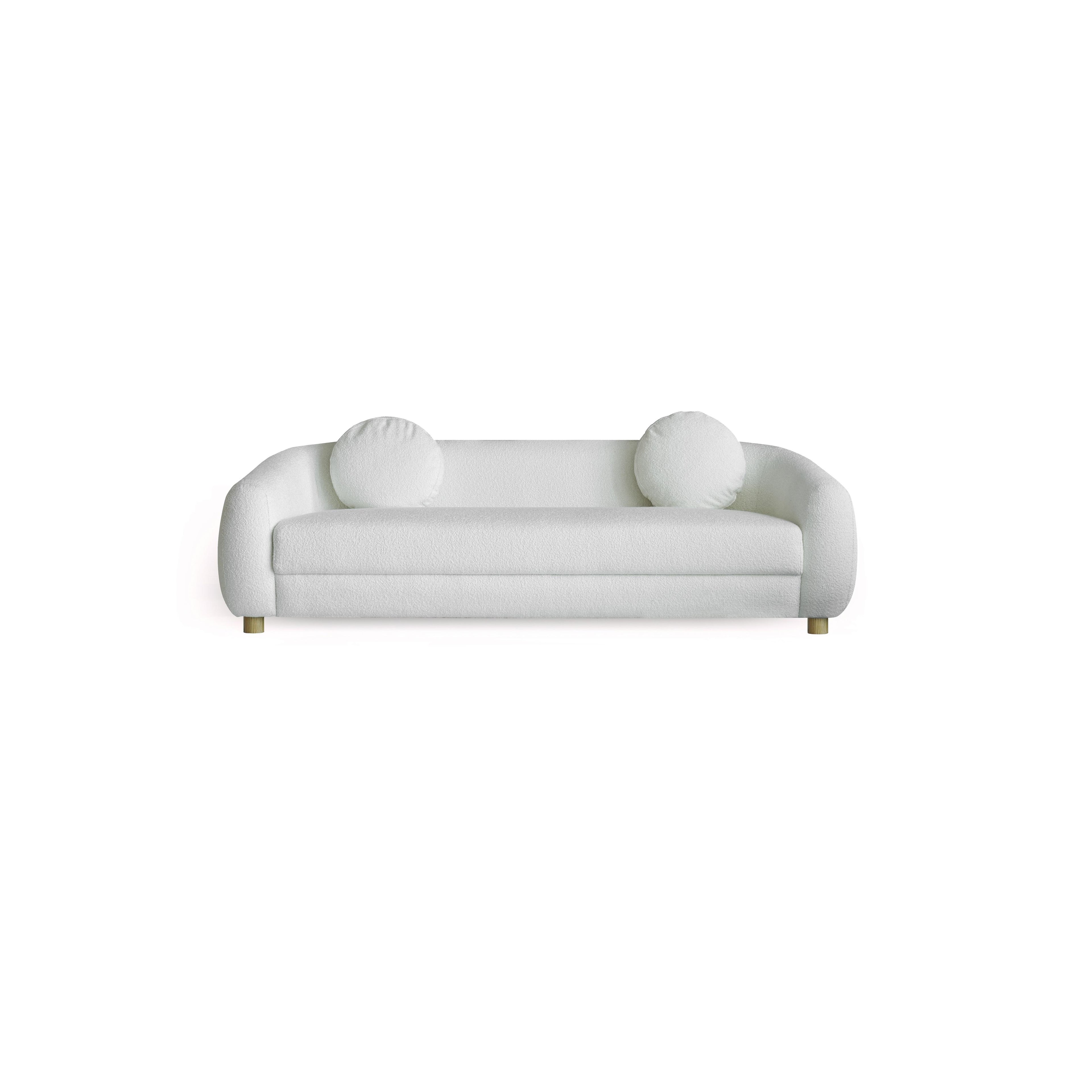 This is a three-seater sofa with rounded arms and a low back, upholstered in a beige, textured fabric. It rests on four small, rounded wooden legs. Designed for seating, it features a continuous cushioned seat and backrest with no visible stitching or fasteners. Category: Furniture > Sofas > Sectionals