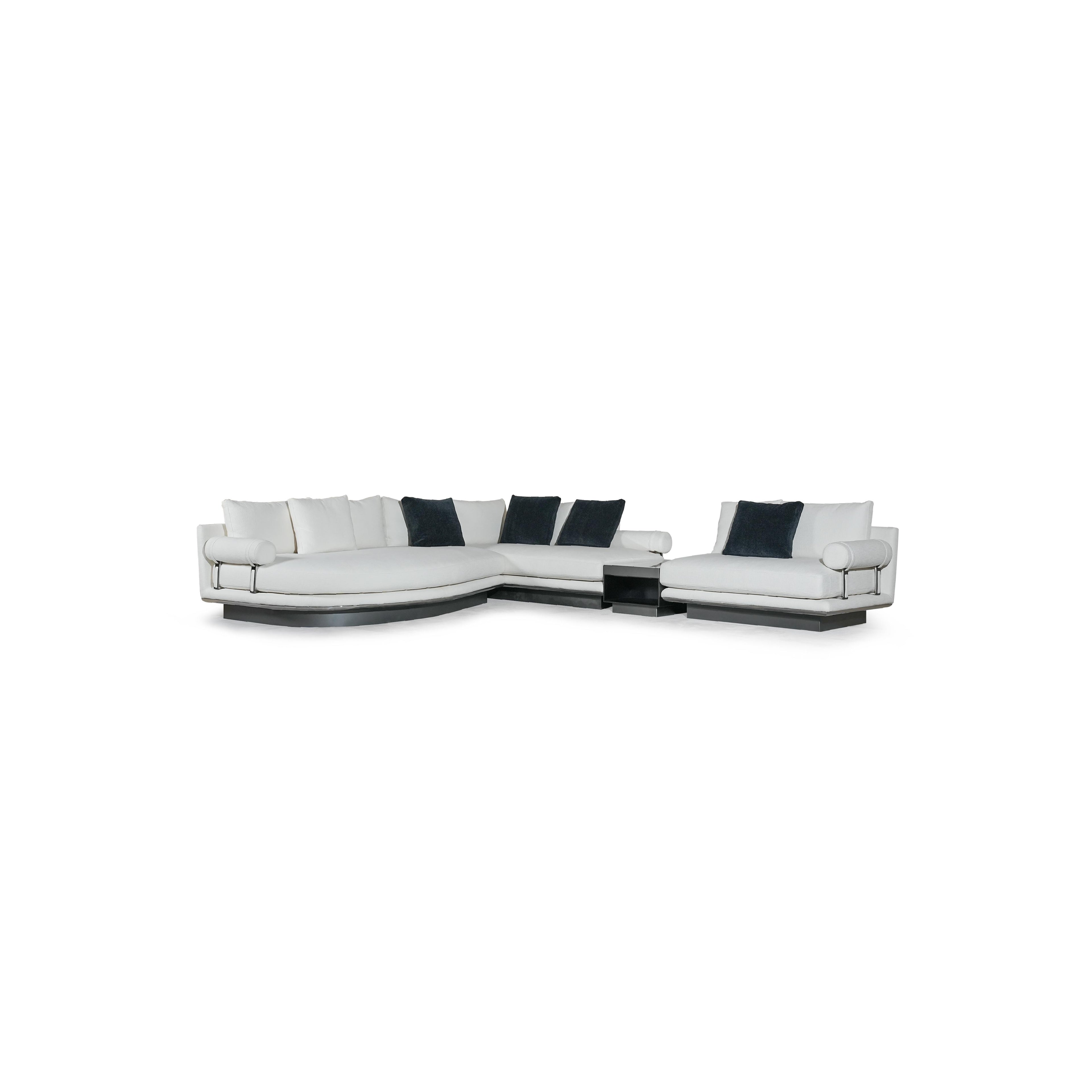 Modern sectional sofa with white upholstered cushions and dark navy throw pillows; L-shaped configuration with rounded arms, low-profile black base, and visible metal frame supports; designed for seating and lounging; Category: furniture > sofas > sectional sofas