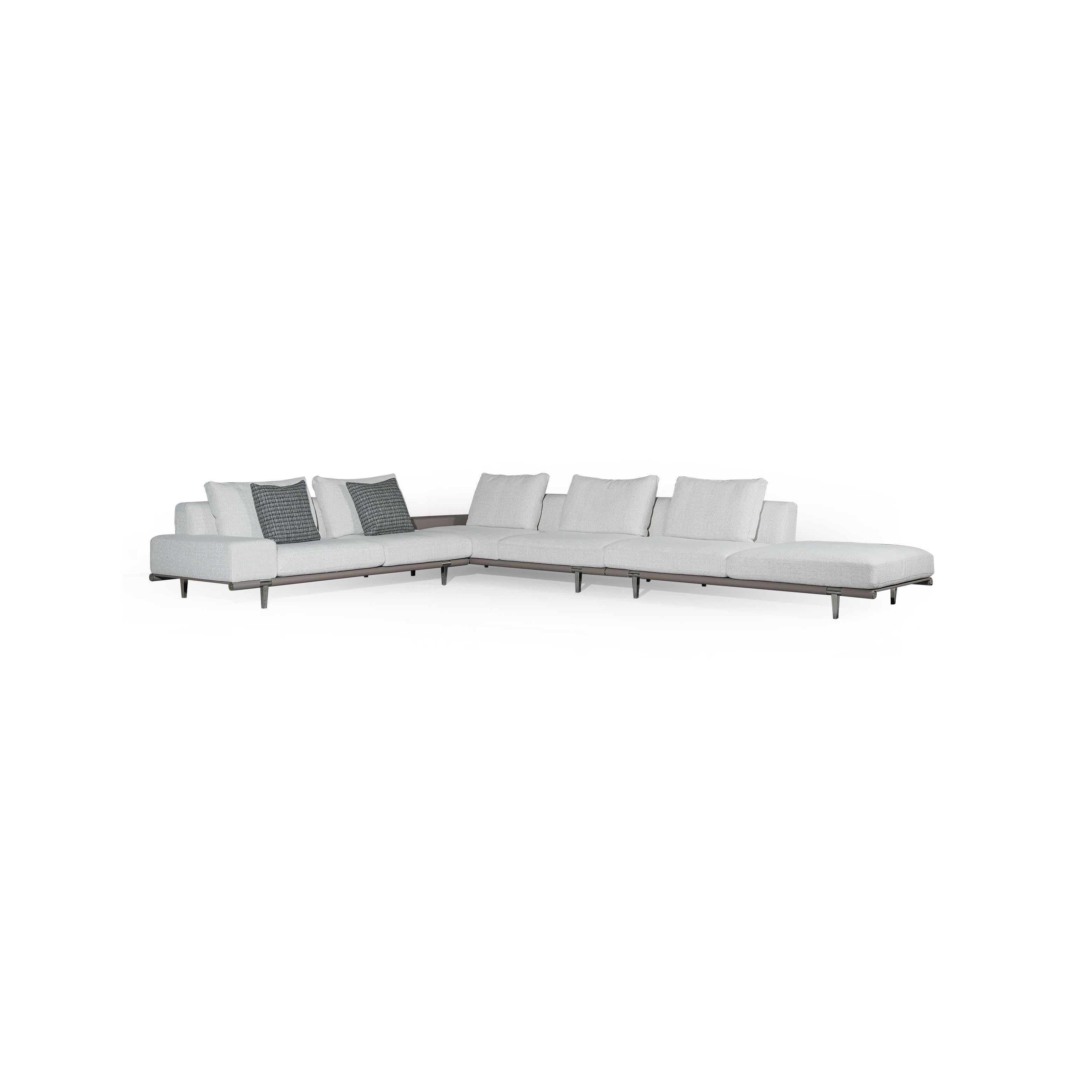 Modern sectional sofa with light gray fabric upholstery, low-profile metal legs, segmented backrest and seat cushions, and two dark patterned throw pillows; designed for lounging and seating in open spaces. Category: furniture/sofas