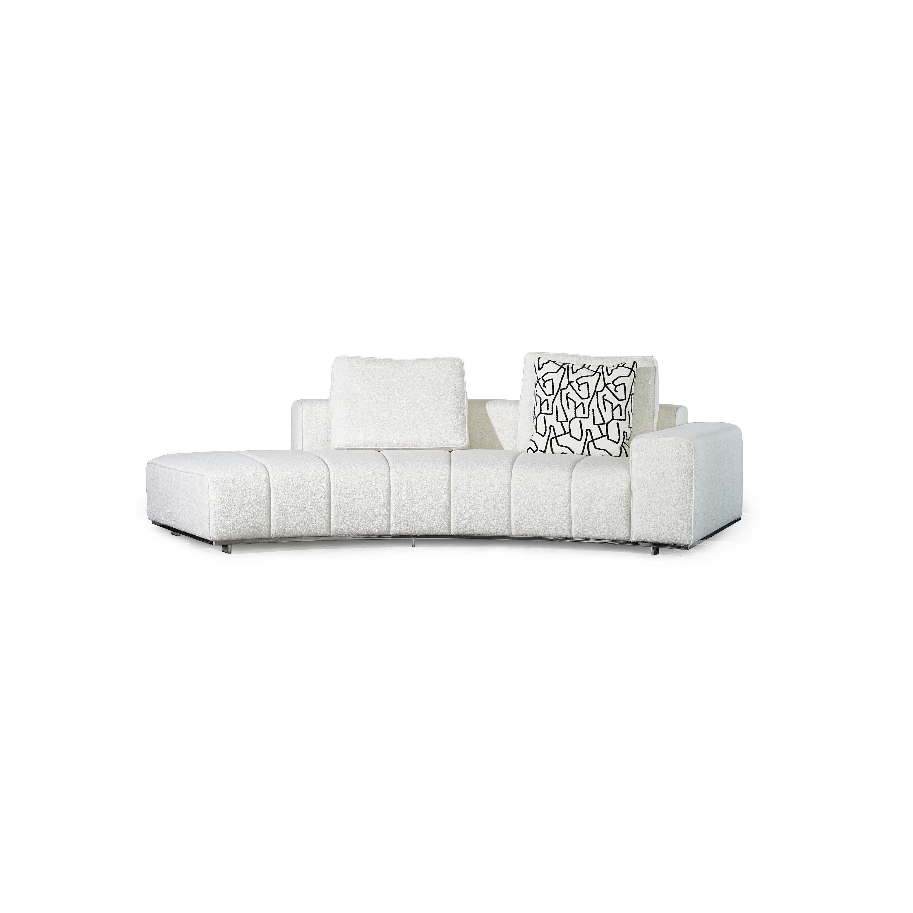 Black leather-like sectional sofa with curved form, featuring segmented cushioning, two patterned throw pillows, and low-profile metal legs; designed for seating and lounging, with visible stitching and defined armrests. Category: furniture/seating/sofas