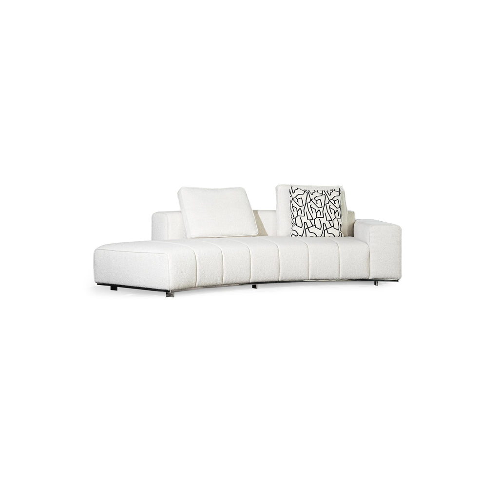 Black leather-like sectional sofa with curved form, featuring segmented cushioning, two patterned throw pillows, and low-profile metal legs; designed for seating and lounging, with visible stitching and defined armrests. Category: furniture/seating/sofas