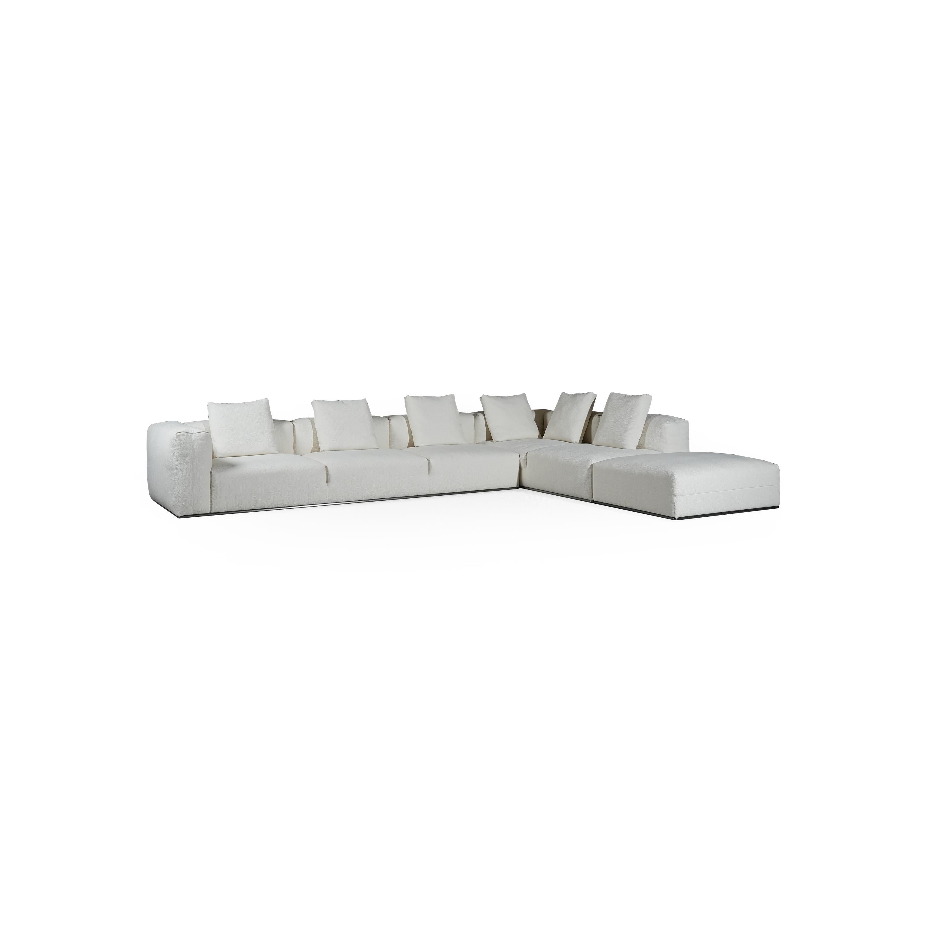 A three-seater sofa with off-white fabric upholstery, featuring segmented cushions, squared arms, and a low-profile metal base. It includes three matching back cushions. Designed for seating, it has a clean, modular form with visible stitching and no visible fasteners or handles. Category: Furniture > Sofas > Sectionals