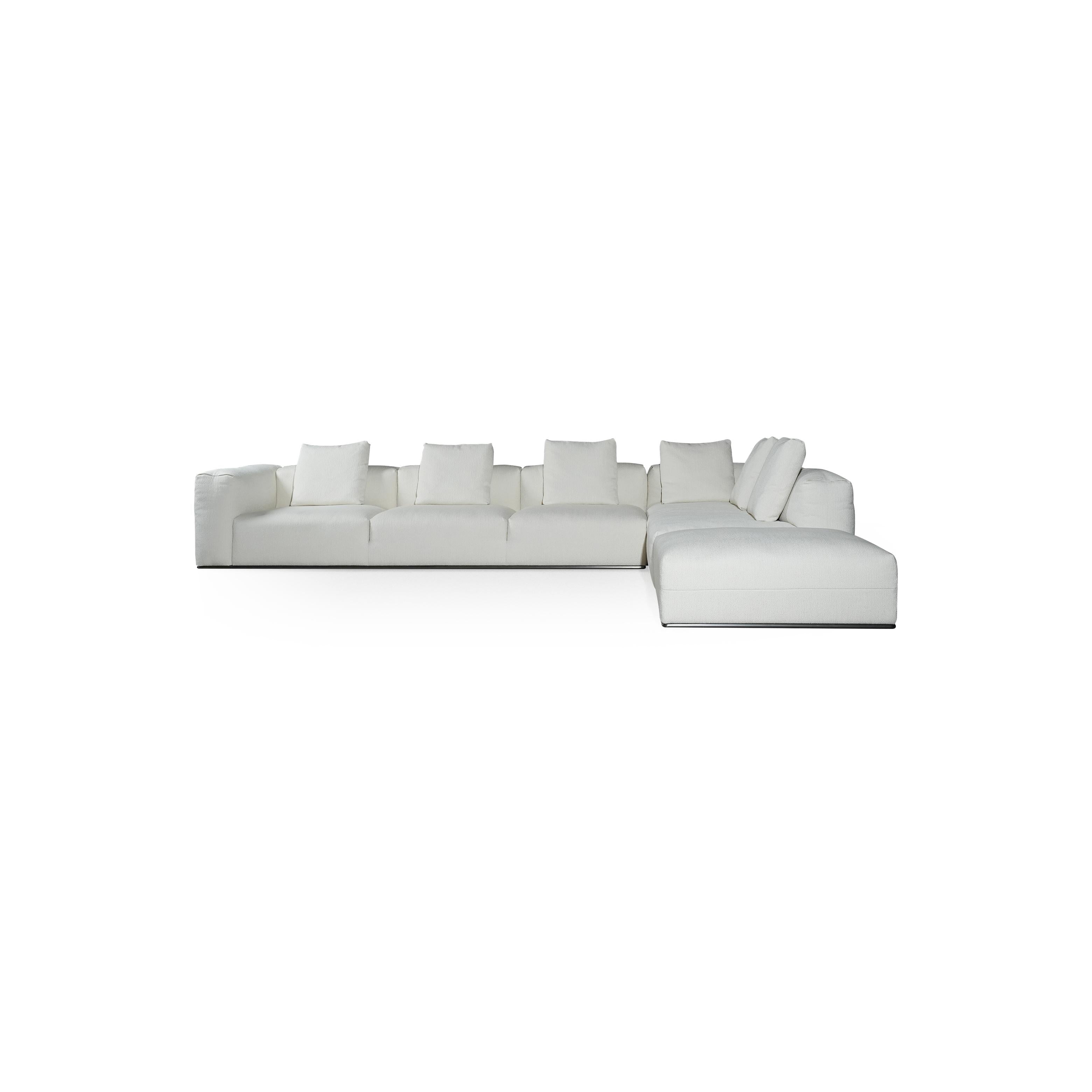 A three-seater sofa with off-white fabric upholstery, featuring segmented cushions, squared arms, and a low-profile metal base. It includes three matching back cushions. Designed for seating, it has a clean, modular form with visible stitching and no visible fasteners or handles. Category: Furniture > Sofas > Sectionals