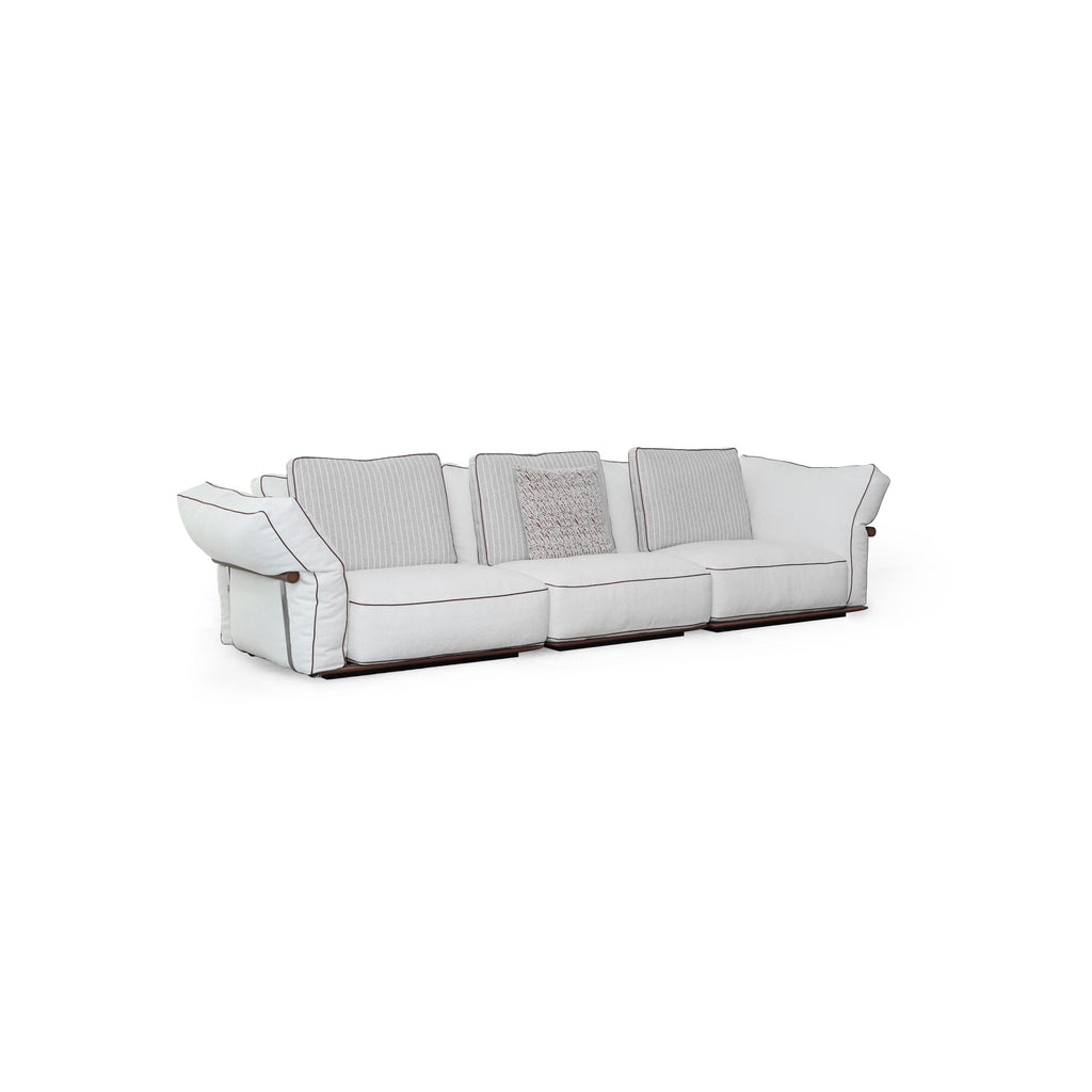 Three-seater sofa with light-colored fabric upholstery, striped back cushions, one textured throw pillow, padded armrests with dark trim, and low-profile dark wooden legs; designed for seating, featuring visible stitching and fabric texture. Category: furniture/southern-style-sofas