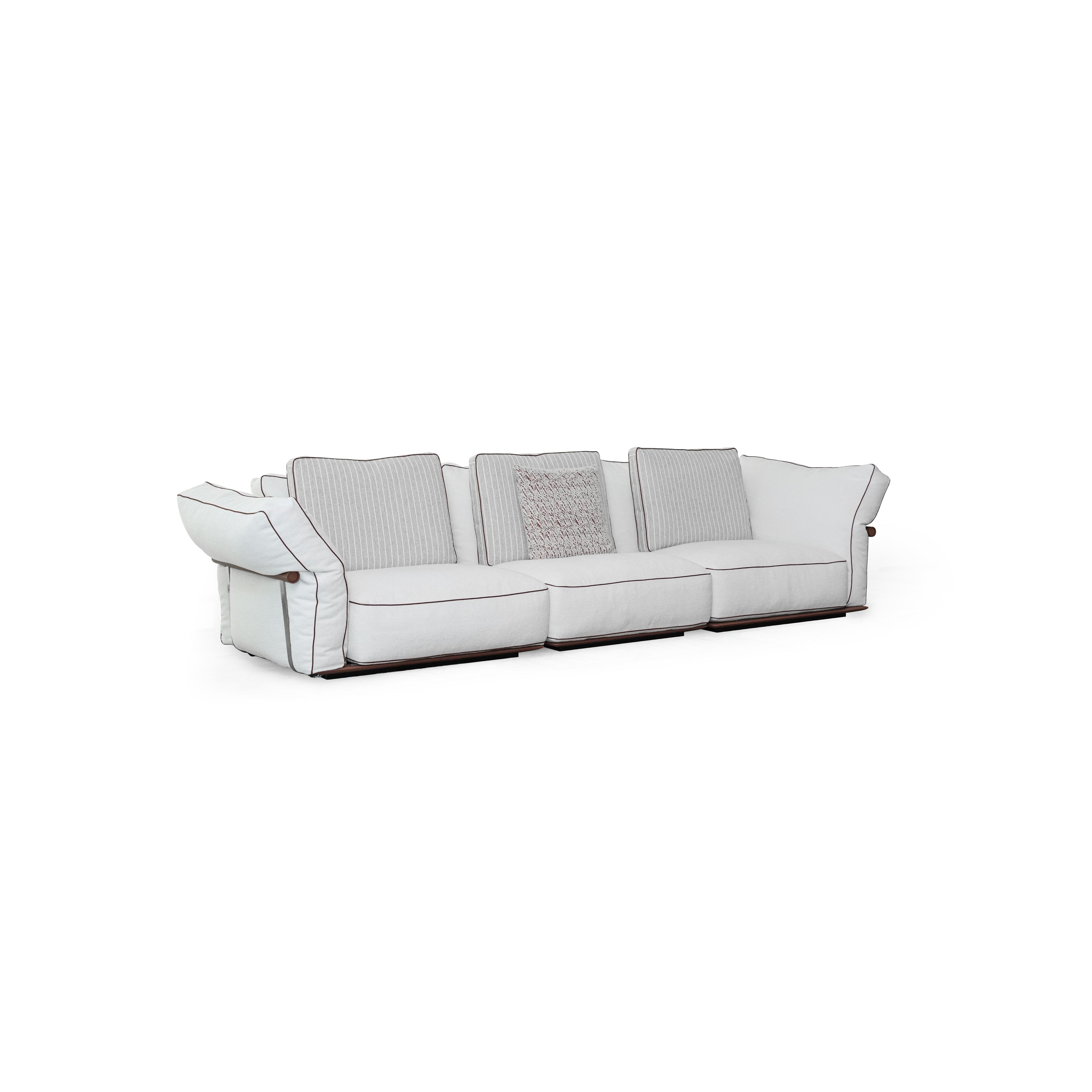 Three-seater sofa with light-colored fabric upholstery, striped back cushions, one textured throw pillow, padded armrests with dark trim, and low-profile dark wooden legs; designed for seating, featuring visible stitching and fabric texture. Category: furniture/southern-style-sofas