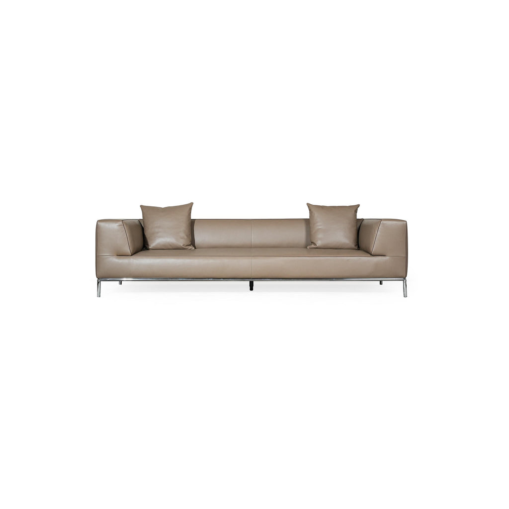 A three-seater sofa with a tan leather-like upholstery, featuring two matching square cushions, rectangular armrests, and a low-profile metal frame with four slender legs. Intended for seating, it has visible stitching along seams and a clean, minimalist silhouette. Category: furniture/southern-style-sofas