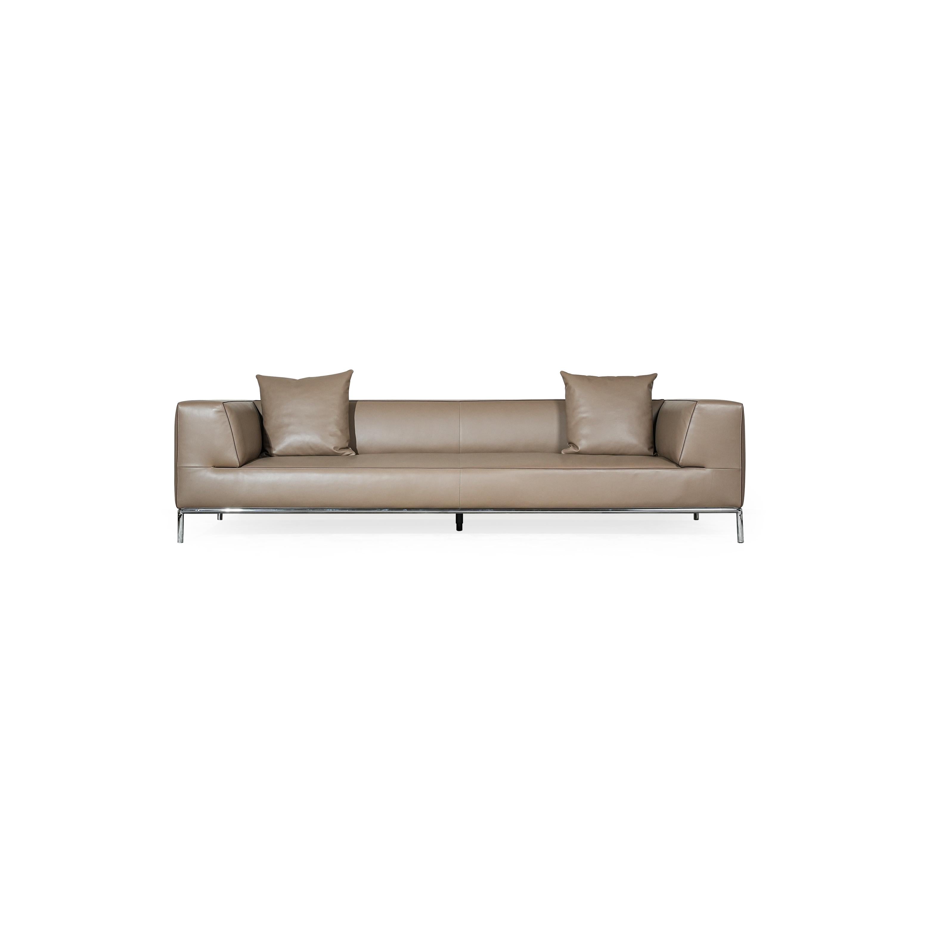 A three-seater sofa with a tan leather-like upholstery, featuring two matching square cushions, rectangular armrests, and a low-profile metal frame with four slender legs. Intended for seating, it has visible stitching along seams and a clean, minimalist silhouette. Category: furniture/southern-style-sofas