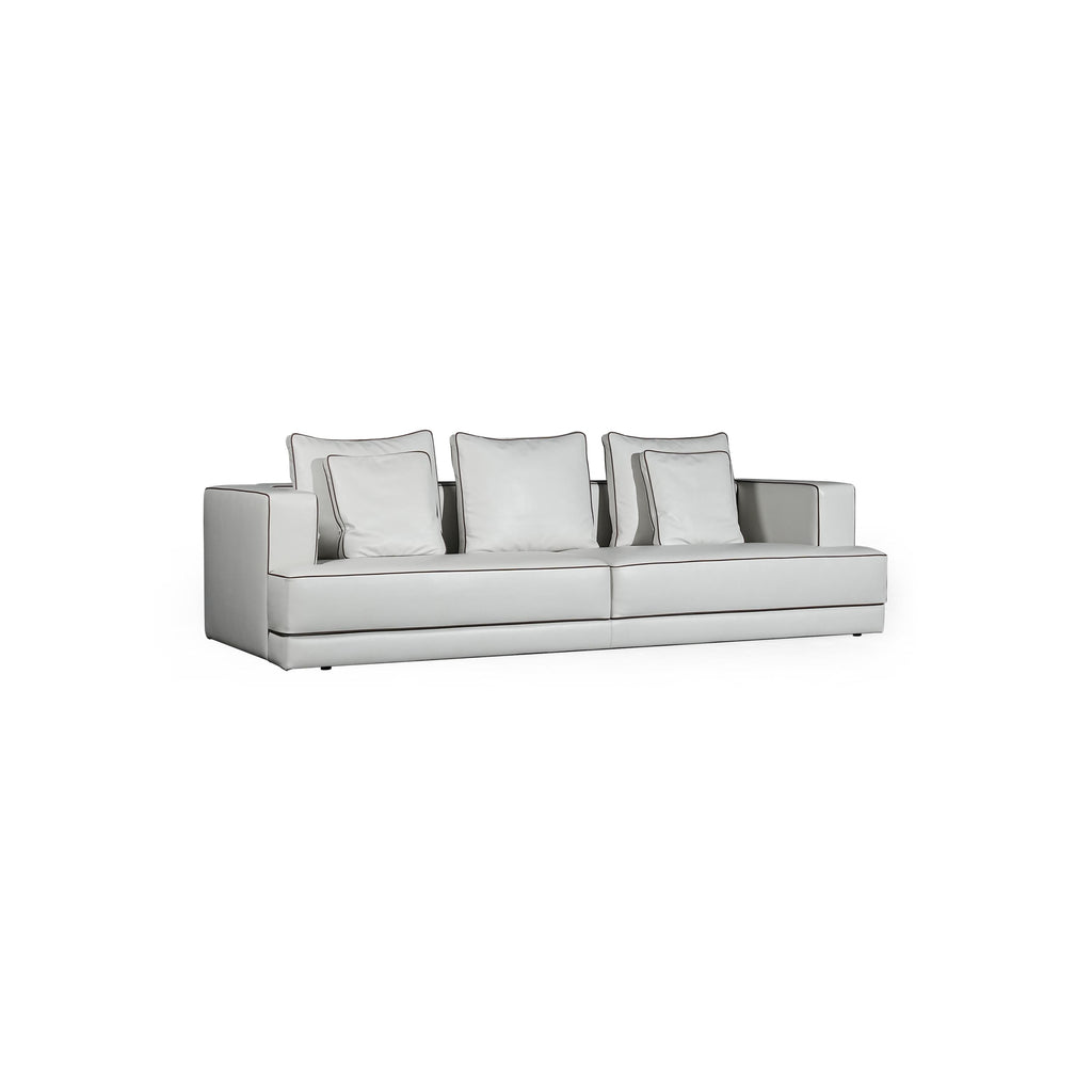A three-seater sofa with light gray upholstery and matching square cushions, featuring defined armrests, a low-profile base, and subtle stitching along seams. Designed for seating, it has a modern, minimalist silhouette with no visible legs or hardware. Category: furniture/southern-style-sofas
