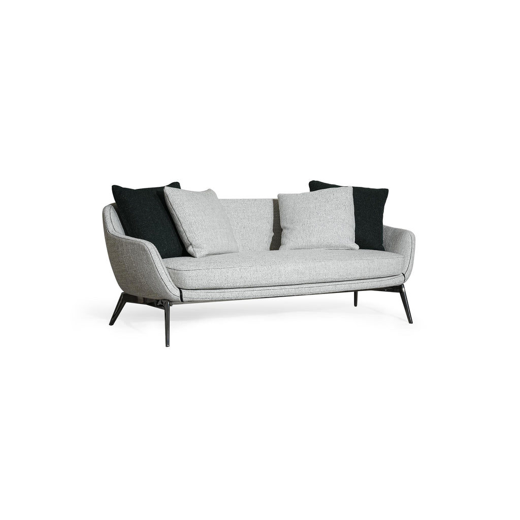 A two-seater sofa with light gray fabric upholstery and black accent pillows, featuring curved armrests, a low-profile backrest, and thin black metal legs. The seat and back cushions are visibly padded with matching fabric. Category: furniture/soups/sofas