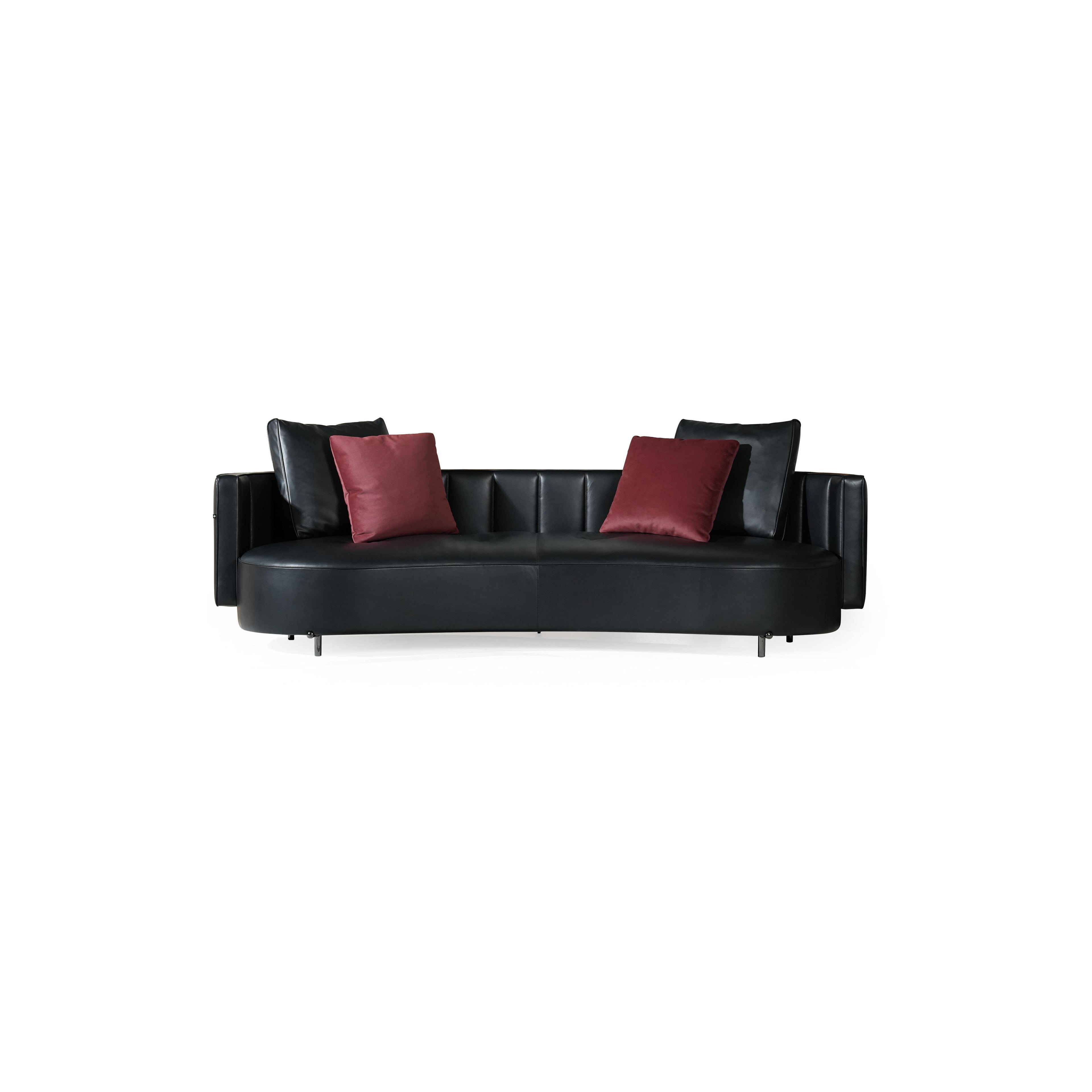 Black leather-like sofa with curved seat and back, featuring two red velvet cushions and two black back cushions; supported by four thin metal legs; designed for seating; Category: Furniture > Sofas > Sectionals