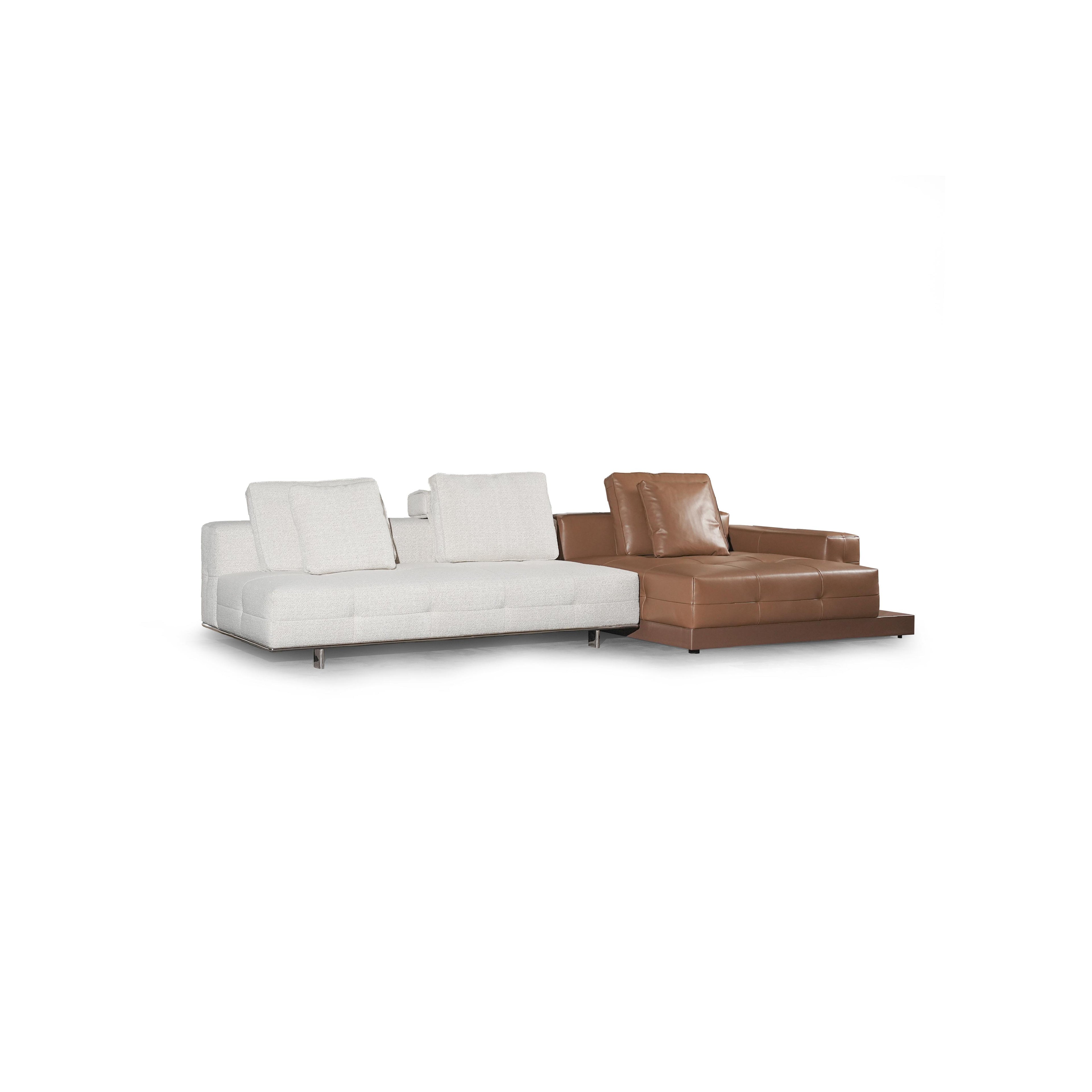 Modern sectional sofa with two-tone upholstery: left side in light textured fabric, right side in tan leather-like material. Features segmented backrests, square cushioned arms, low-profile metal legs, and distinct stitching. Designed for seating and lounging. Category: furniture/sofas