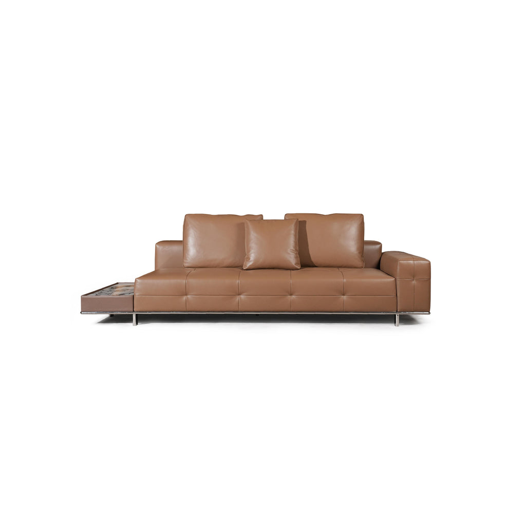 Modern sectional sofa with two-tone upholstery: left side in light textured fabric, right side in tan leather-like material. Features segmented backrests, square cushioned arms, low-profile metal legs, and distinct stitching. Designed for seating and lounging. Category: furniture/sofas