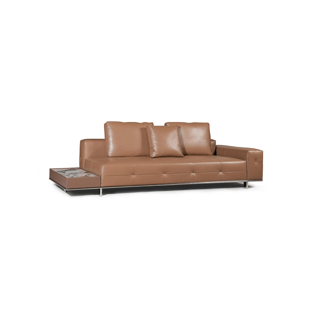 Modern sectional sofa with two-tone upholstery: left side in light textured fabric, right side in tan leather-like material. Features segmented backrests, square cushioned arms, low-profile metal legs, and distinct stitching. Designed for seating and lounging. Category: furniture/sofas