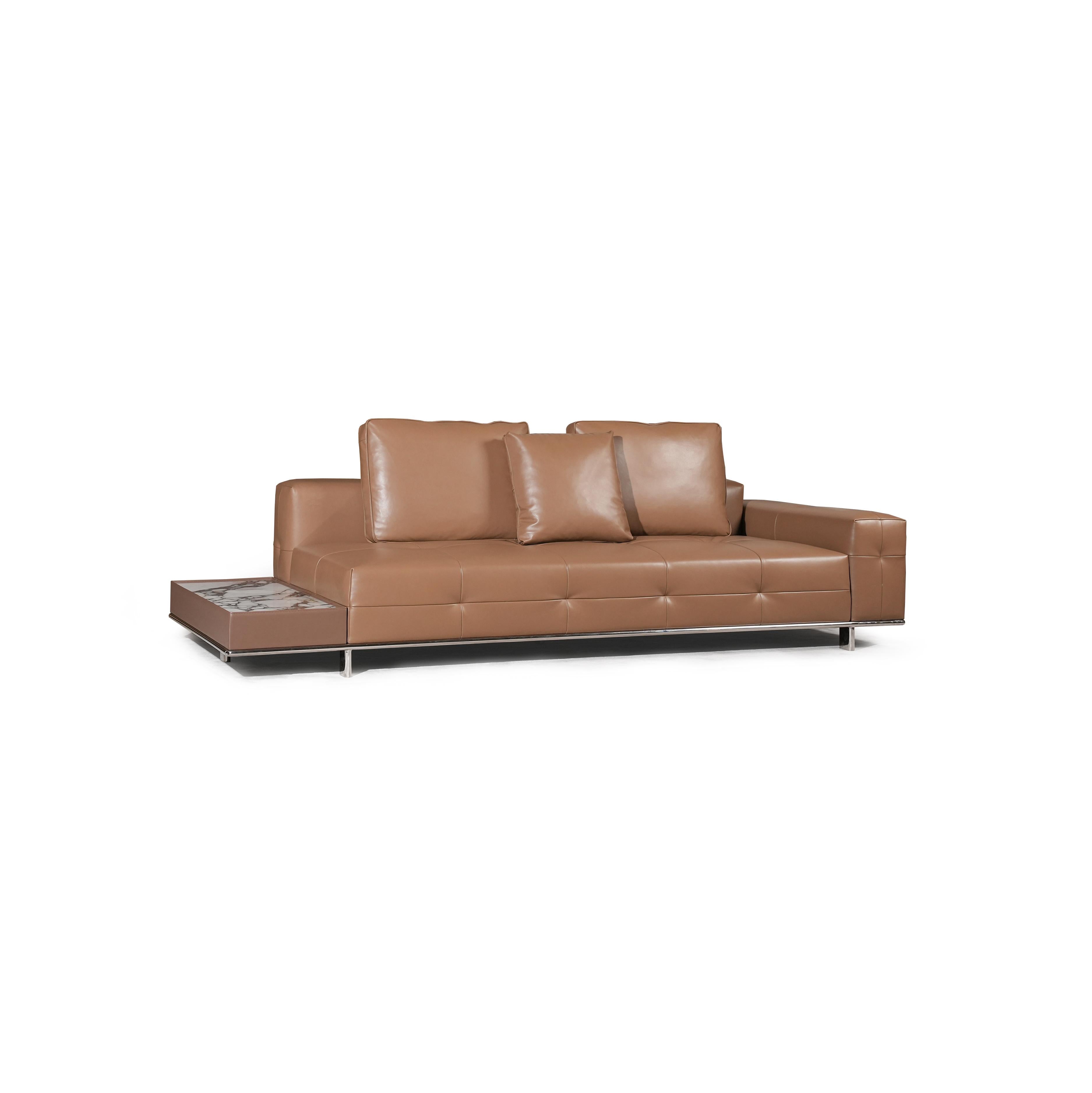 Modern sectional sofa with two-tone upholstery: left side in light textured fabric, right side in tan leather-like material. Features segmented backrests, square cushioned arms, low-profile metal legs, and distinct stitching. Designed for seating and lounging. Category: furniture/sofas