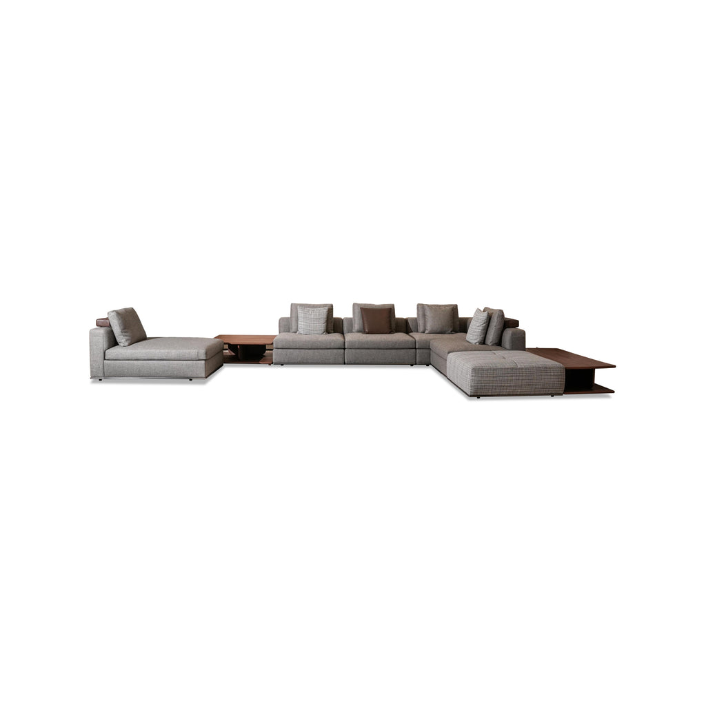 Modular sectional sofa with gray fabric upholstery, dark wood coffee table, and matching side tables; includes multiple cushions, low-profile legs, and visible stitching; designed for seating and lounging; Category: furniture > sofas > sectional sofas
