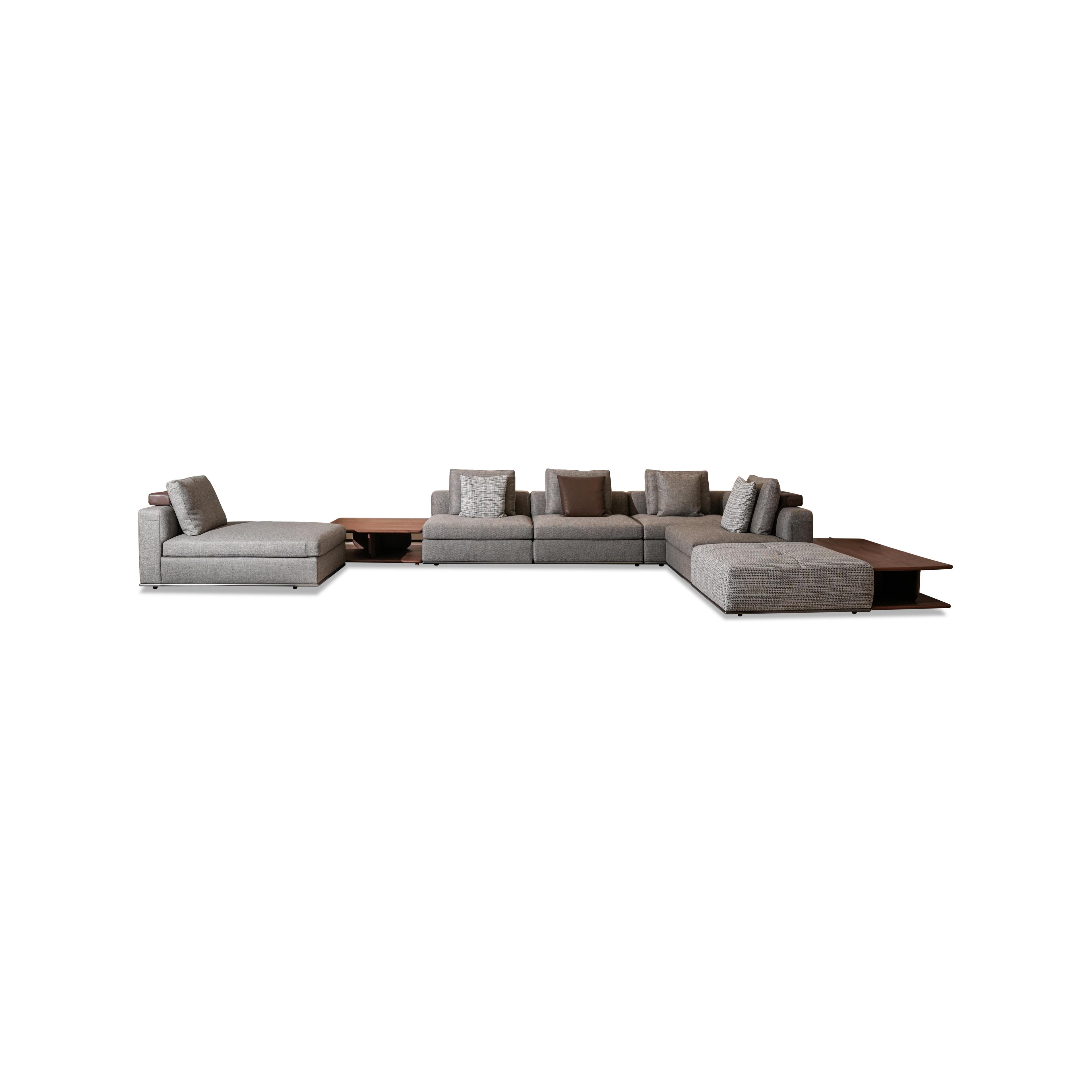 Modular sectional sofa with gray fabric upholstery, dark wood coffee table, and matching side tables; includes multiple cushions, low-profile legs, and visible stitching; designed for seating and lounging; Category: furniture > sofas > sectional sofas