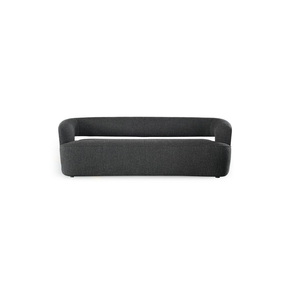 Dark gray upholstered sofa with rounded arms and low backrest, featuring a single cushioned seat and two small feet. Fabric has a textured weave. Designed for seating. Category: furniture/sofas